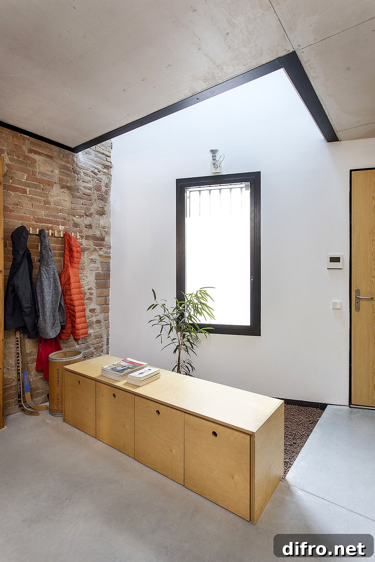 Entry with skylight illuminating white, brick and wood finishes at Casa EP15340