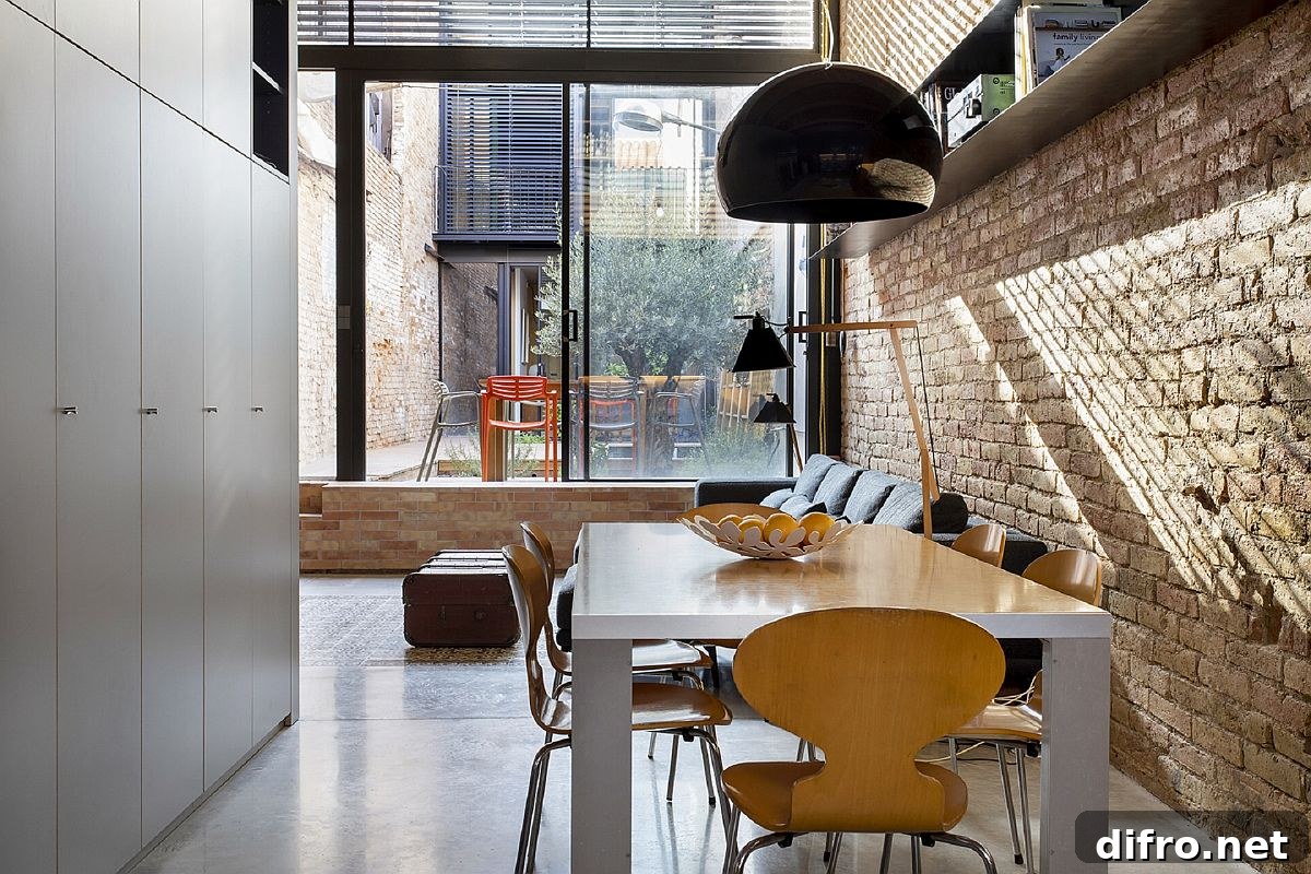 Dining room at Casa EP15340 with natural light and brick walls merging contemporary design