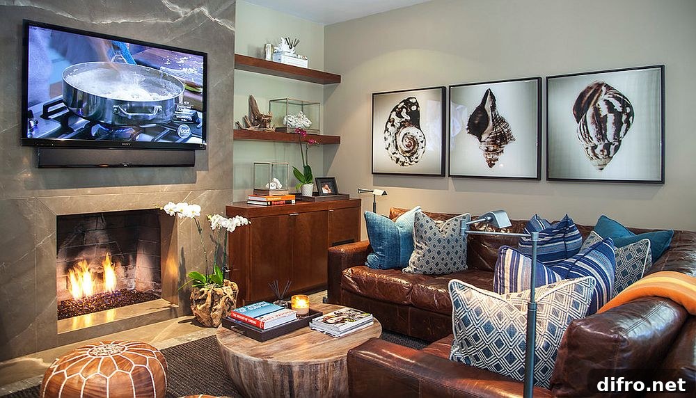 A modern media room with art on the wall and a large TV above a fireplace.