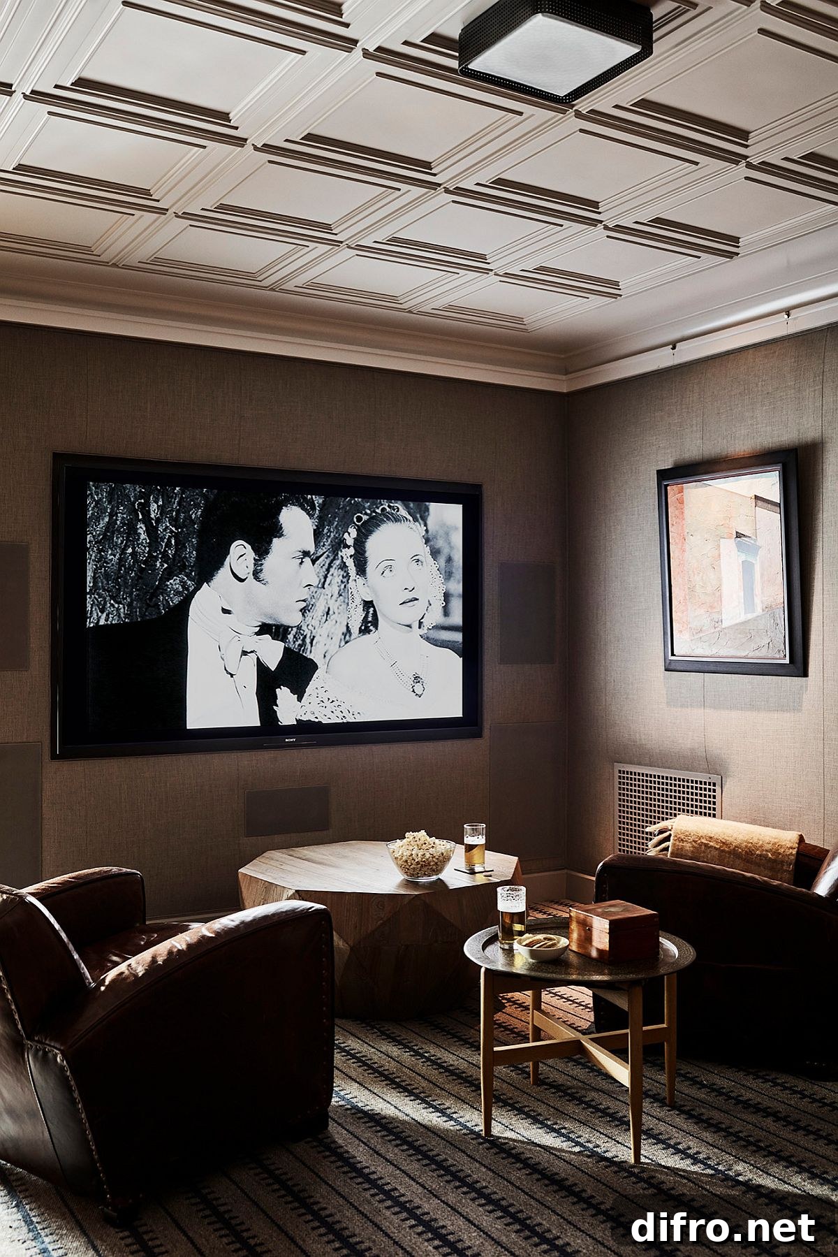 A dark media room with leather couches.