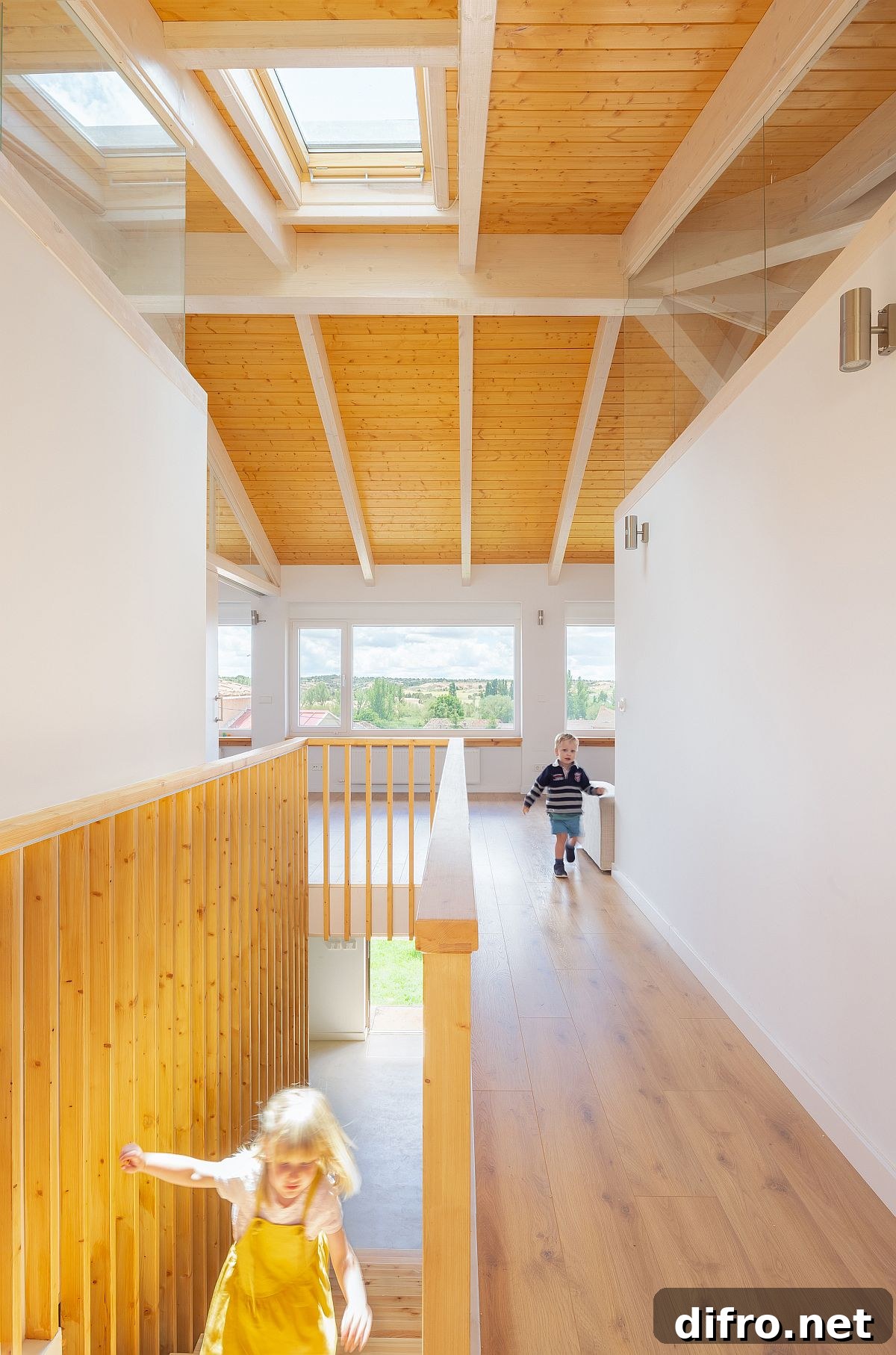 Crisscrossing white ceiling beams on the upper level