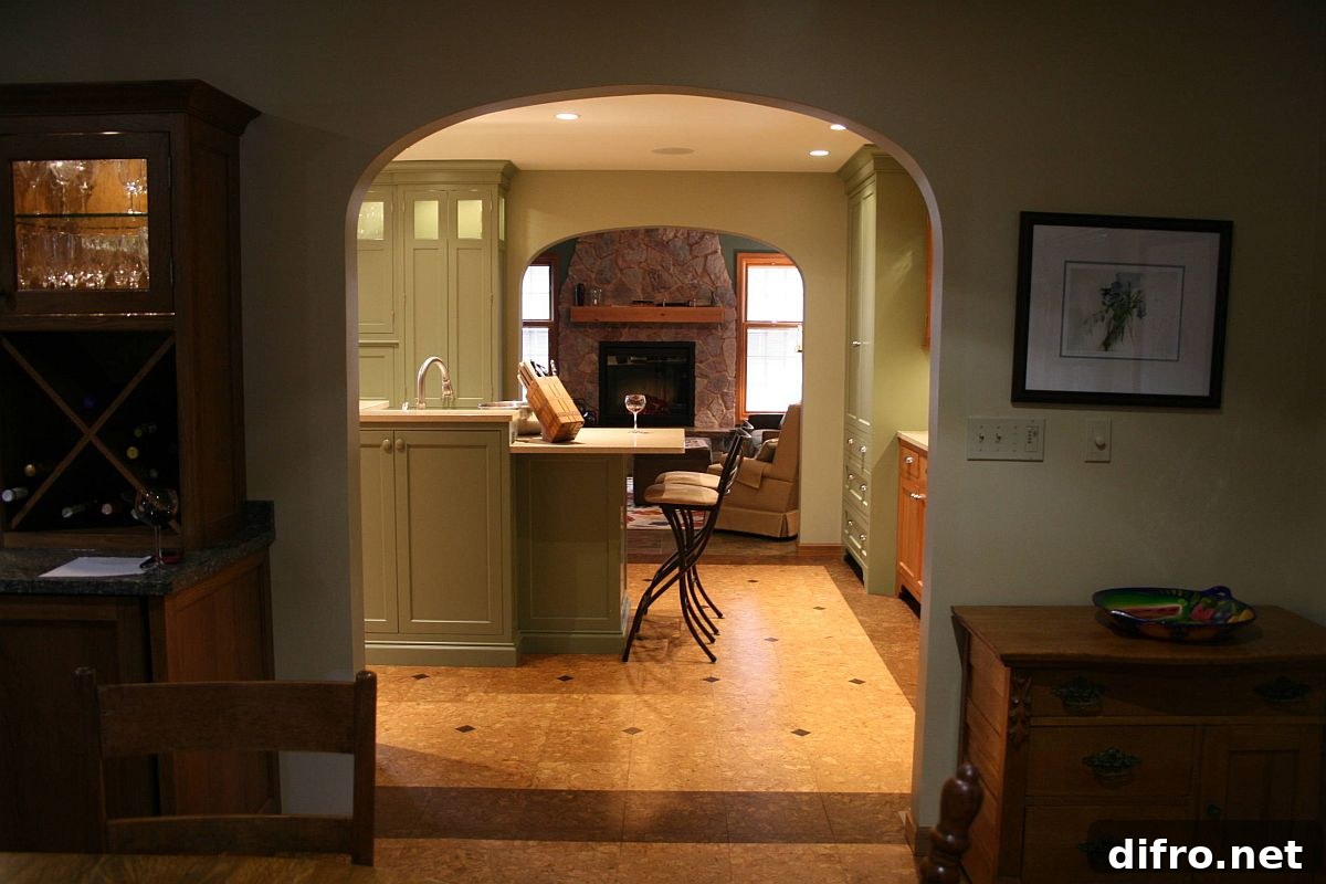 Green walls and cabinets add color to the kitchen with cork floor