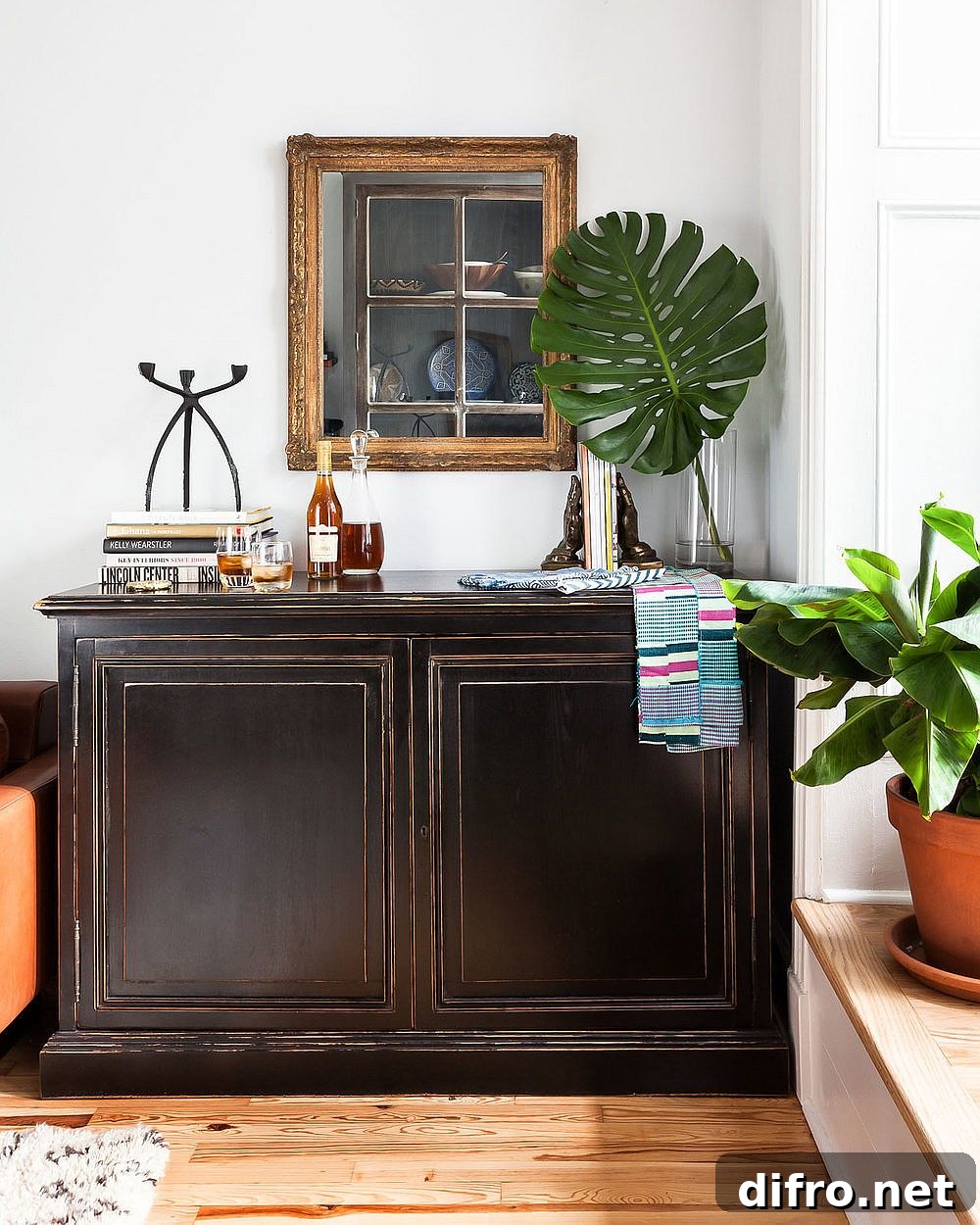Wooden credenza decorated with greenery