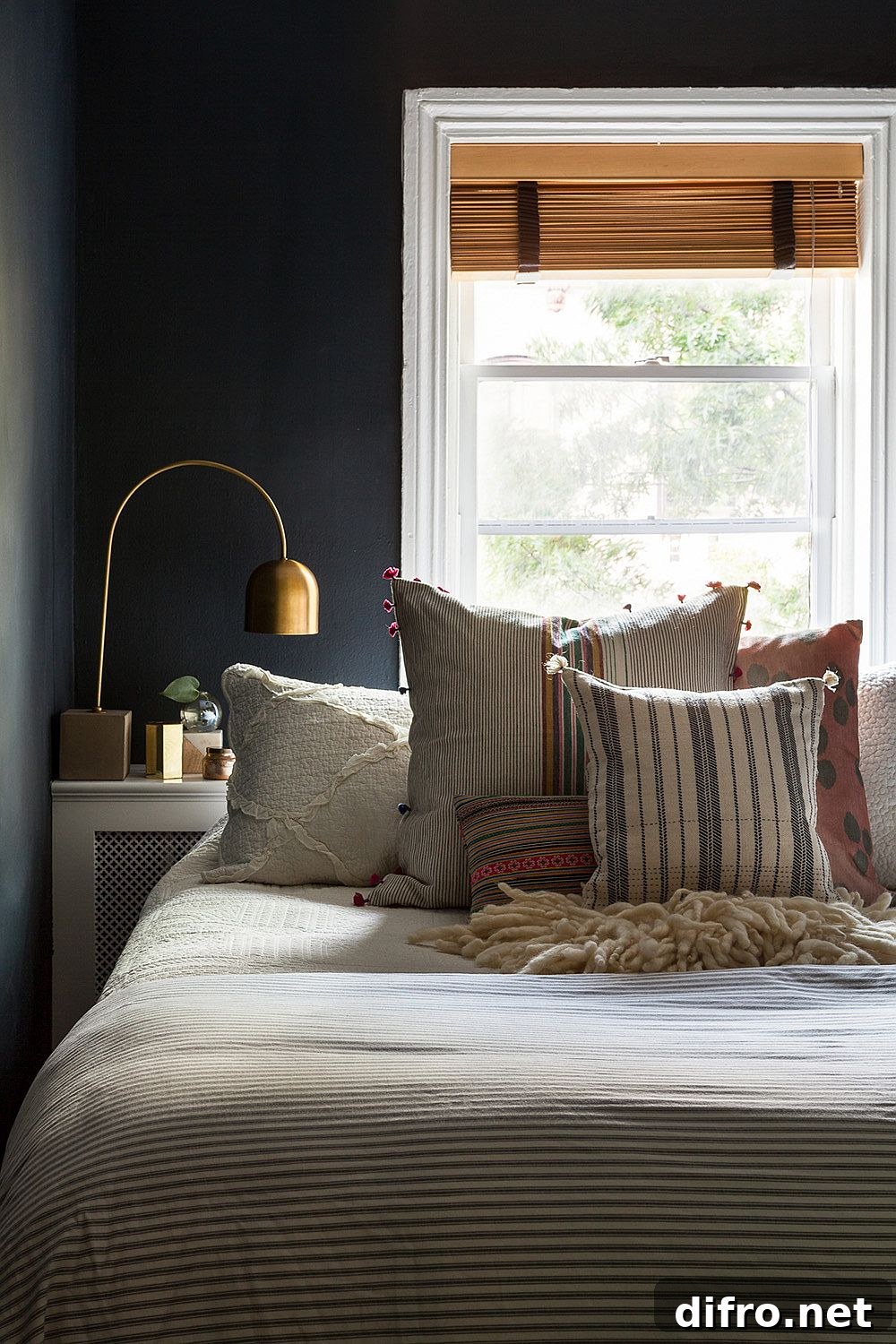 Small bedroom with dark gray walls and large window
