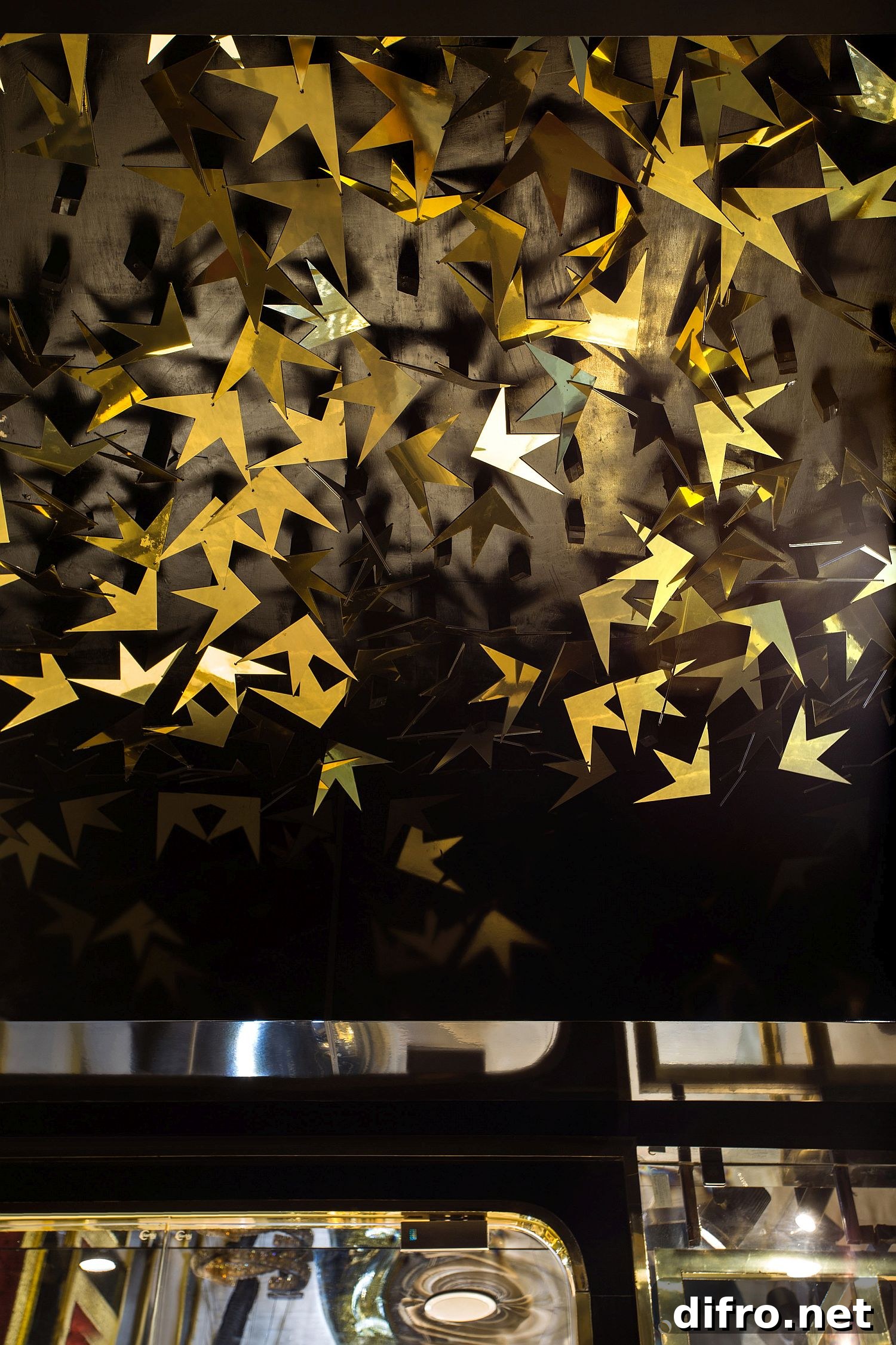 Black backdrop with leaf-like gold design at Swarn Jewellers