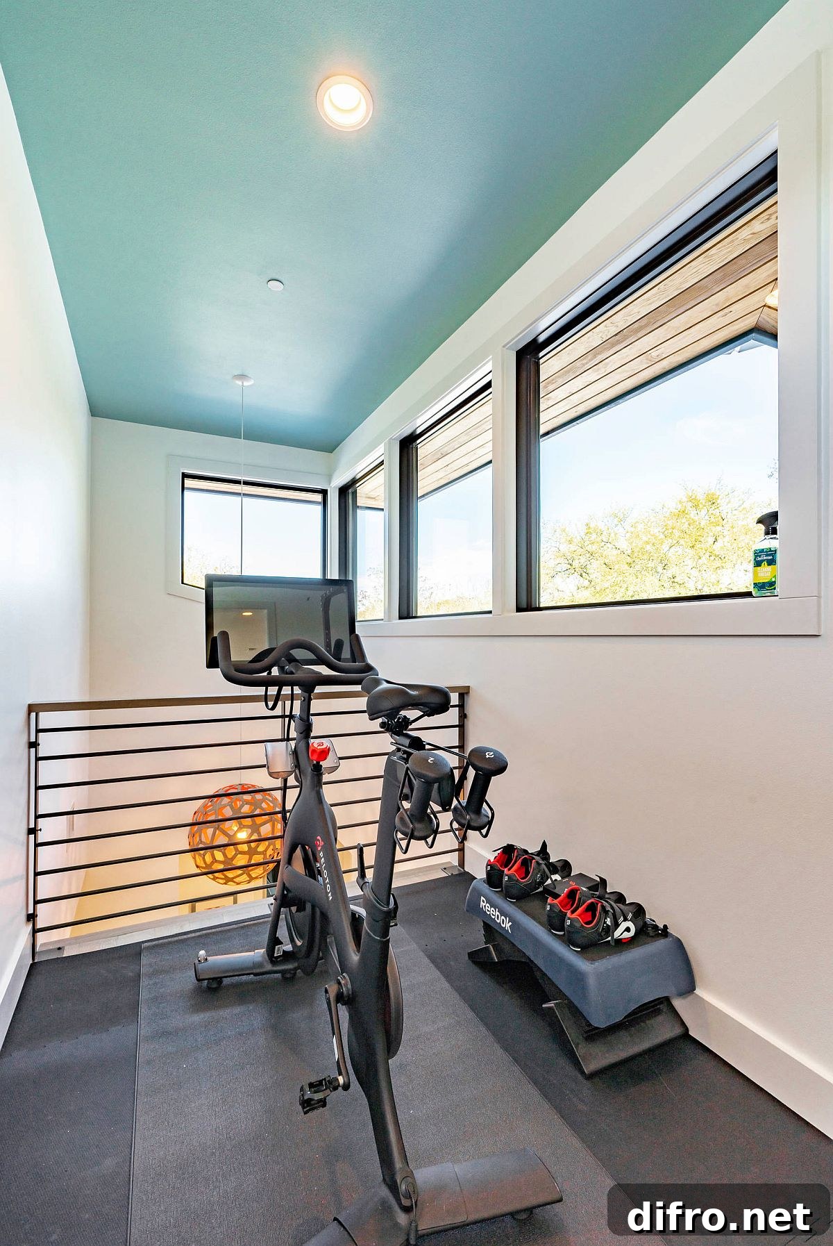 Tiny niche next to the stairwell turned into a small home gym with non-slip flooring