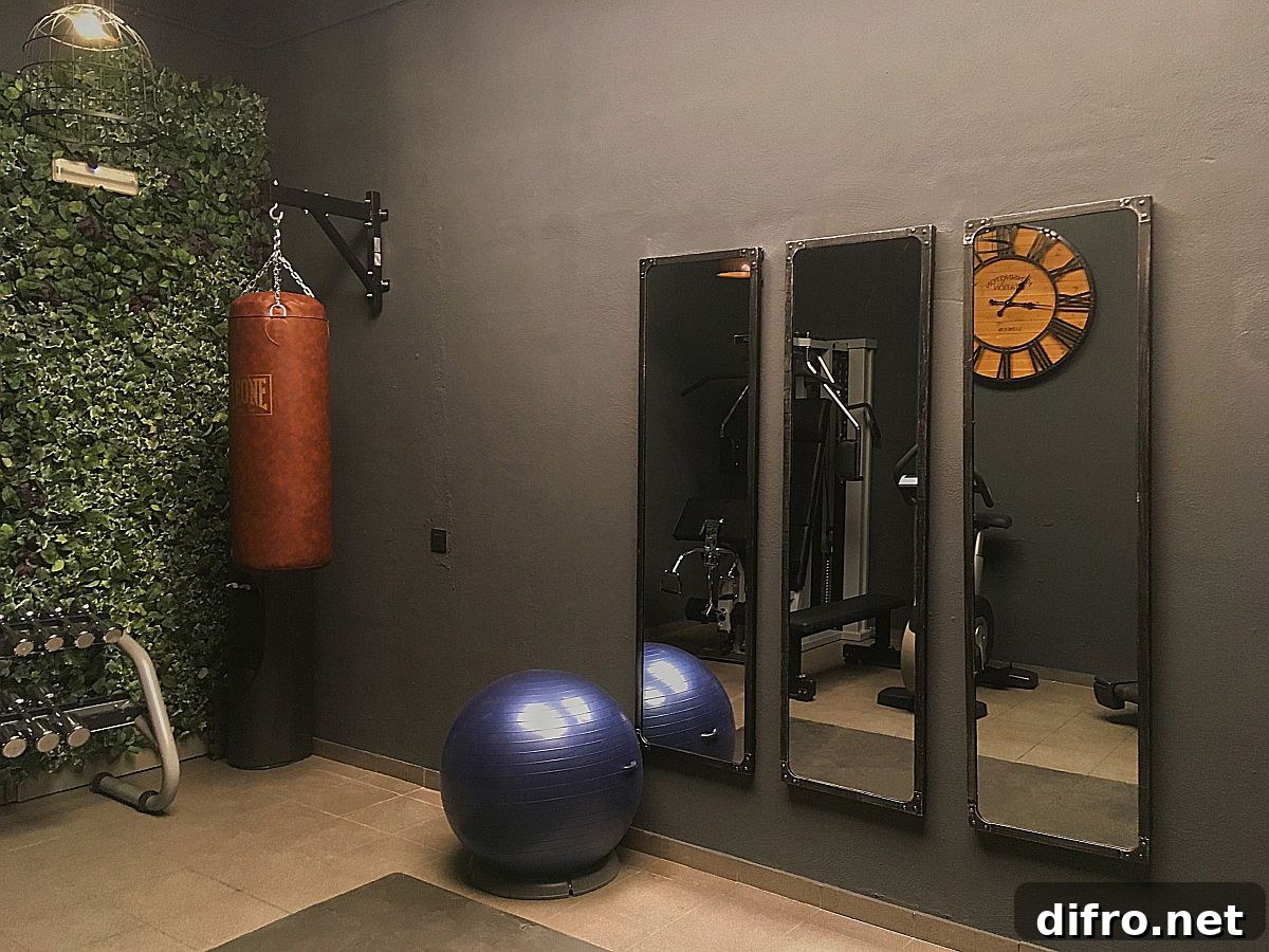 Small basement home gym with mirrors and green wall