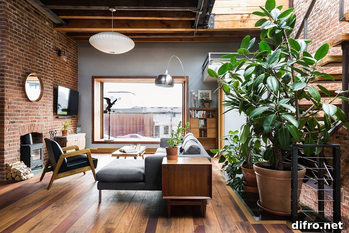 Industrial style living room where brick walls and wooden floor add ample contrast
