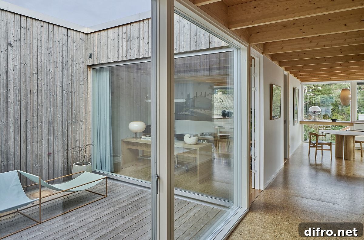 Scandinavian-style wooden atrium with sliding glass doors