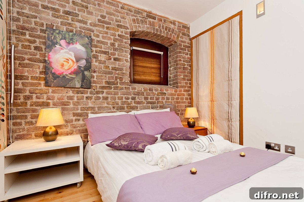 Custom interior with brick wall backdrop in a small eclectic bedroom
