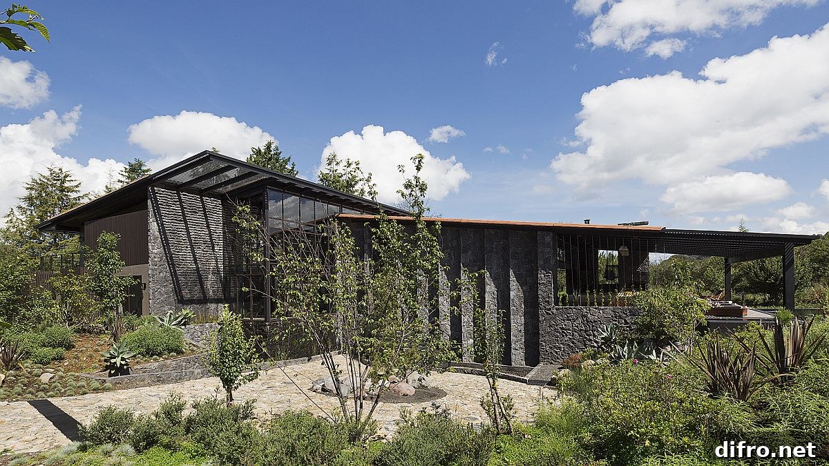 Slanting roof forms and volcanic stone wall detail