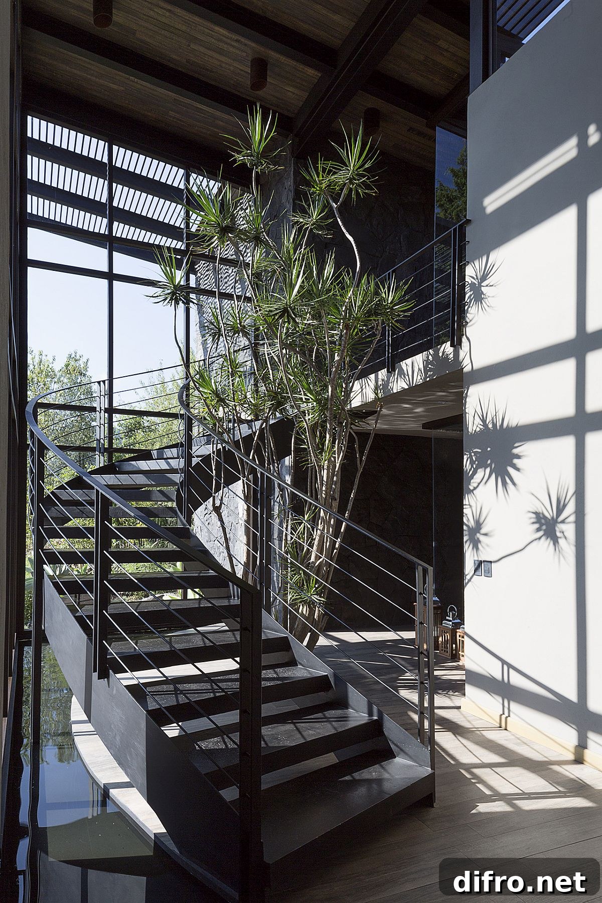 Curving staircase and water feature at the house entrance
