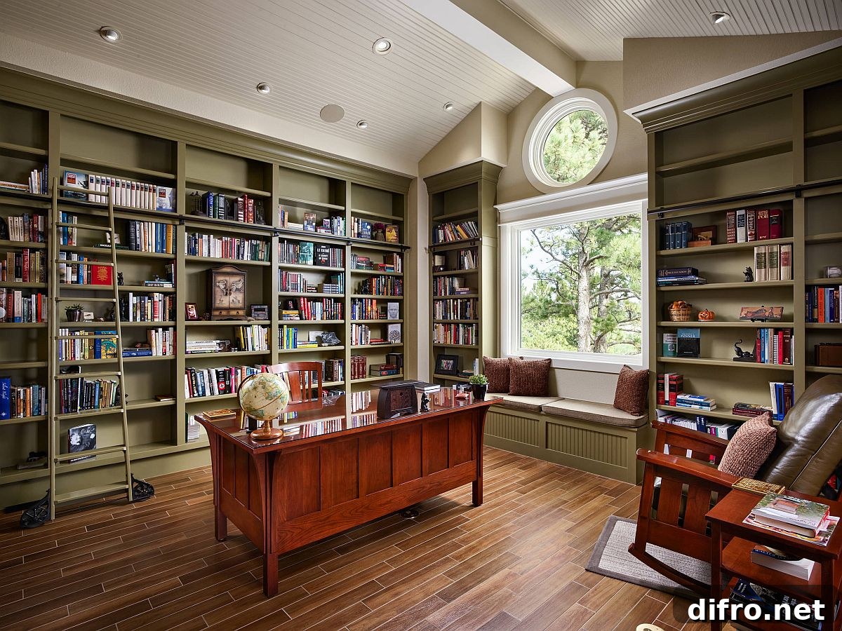 home office with floor to ceiling olive green book shelves