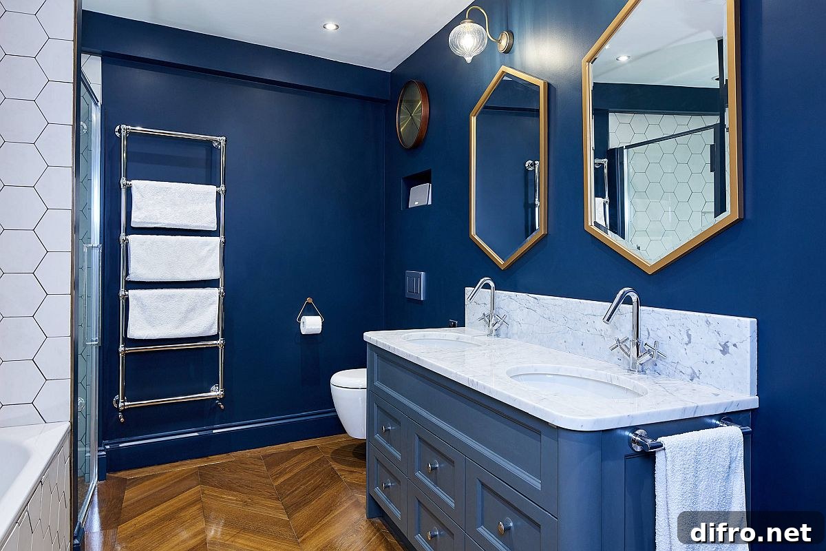 Hexagonal mirrors with metallic frames in a blue and white bathroom