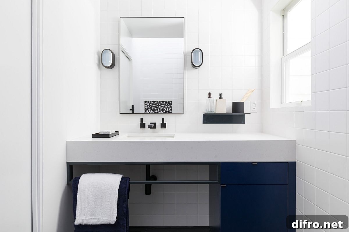 Monochromatic bathroom in white with deep blue cabinets