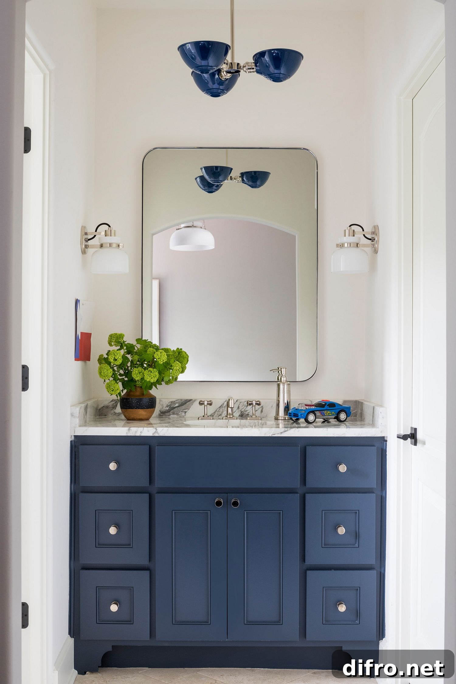 A blue vanity in a white bathroom