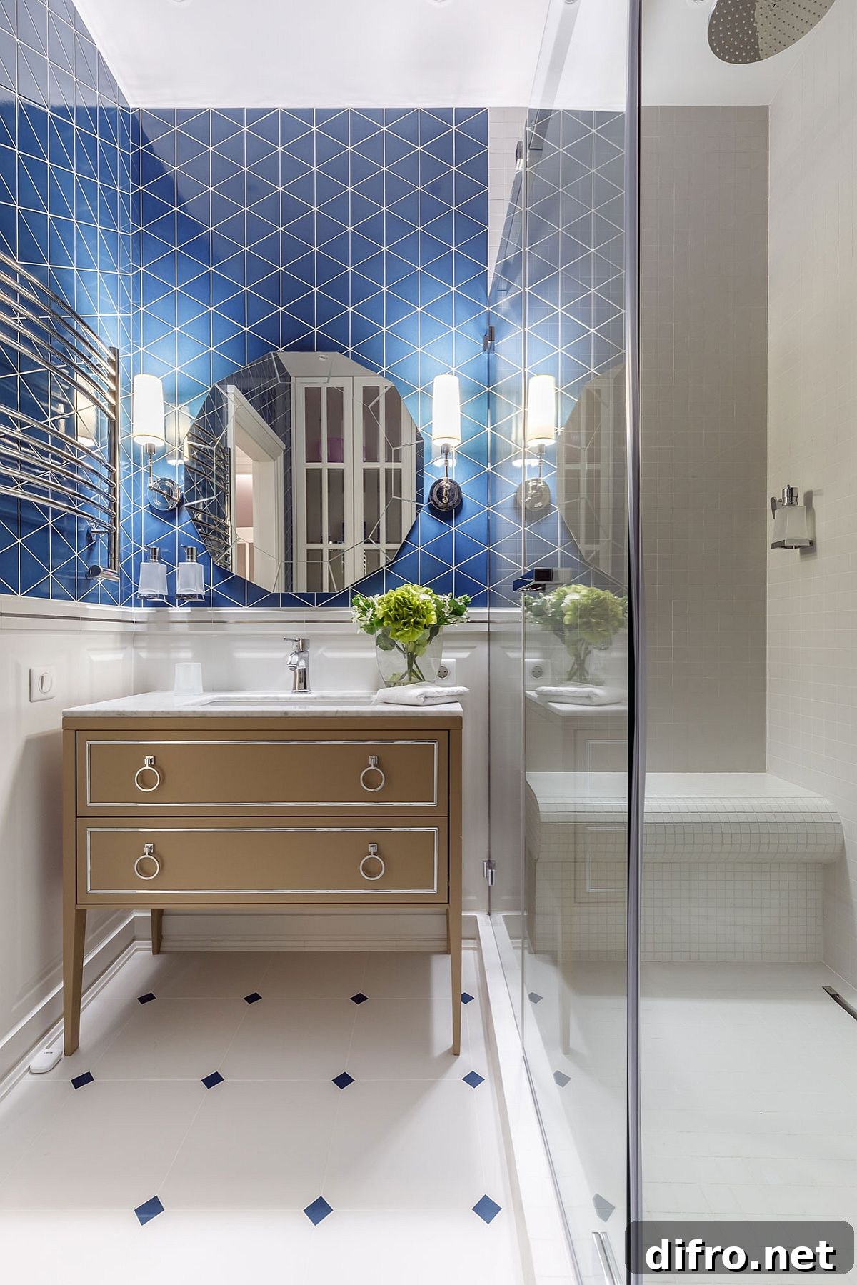 Blue tiles adding pattern and color to a small white bathroom