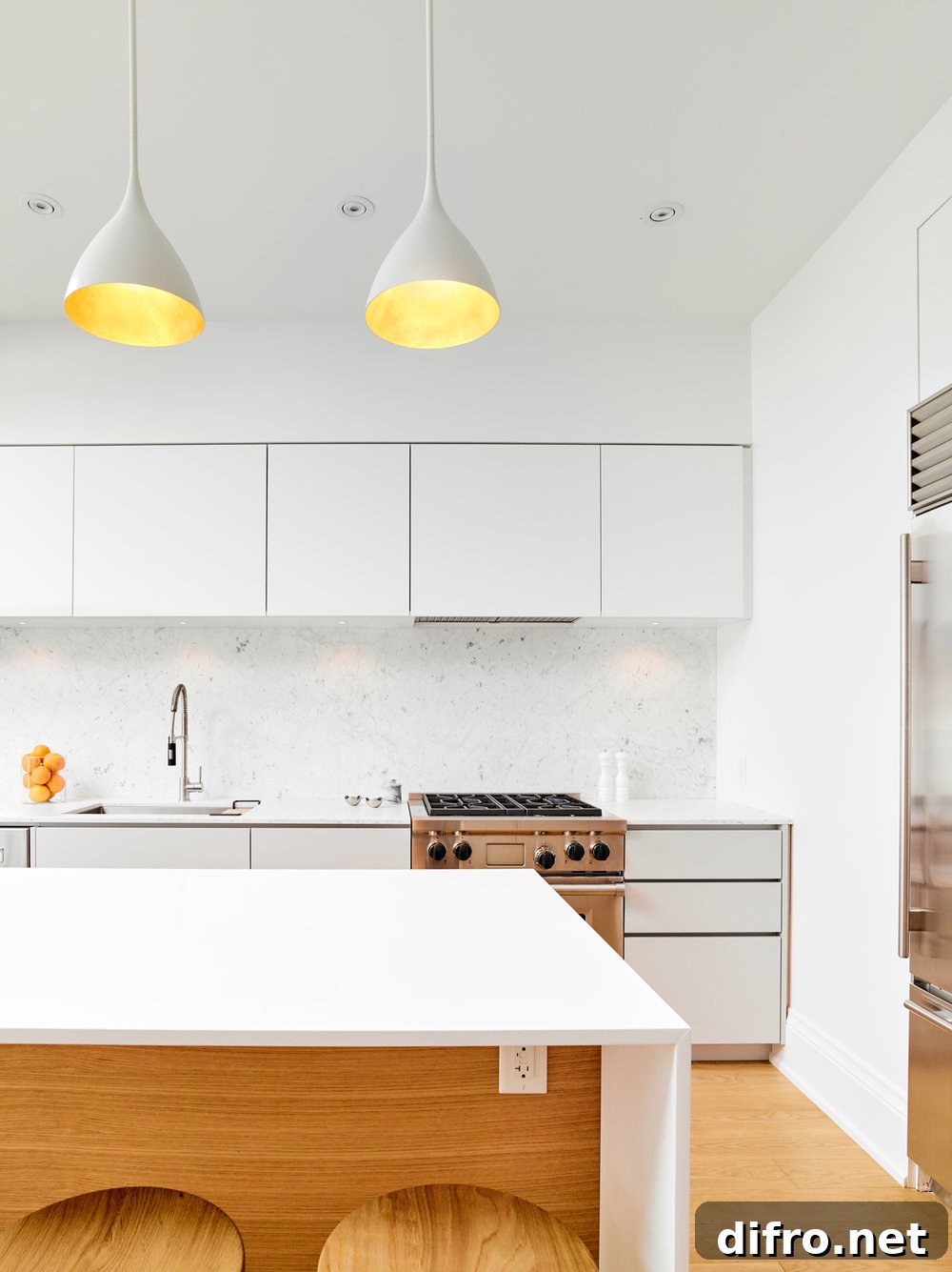 Pendant lights accentuate the kitchen's modern-minimalist style