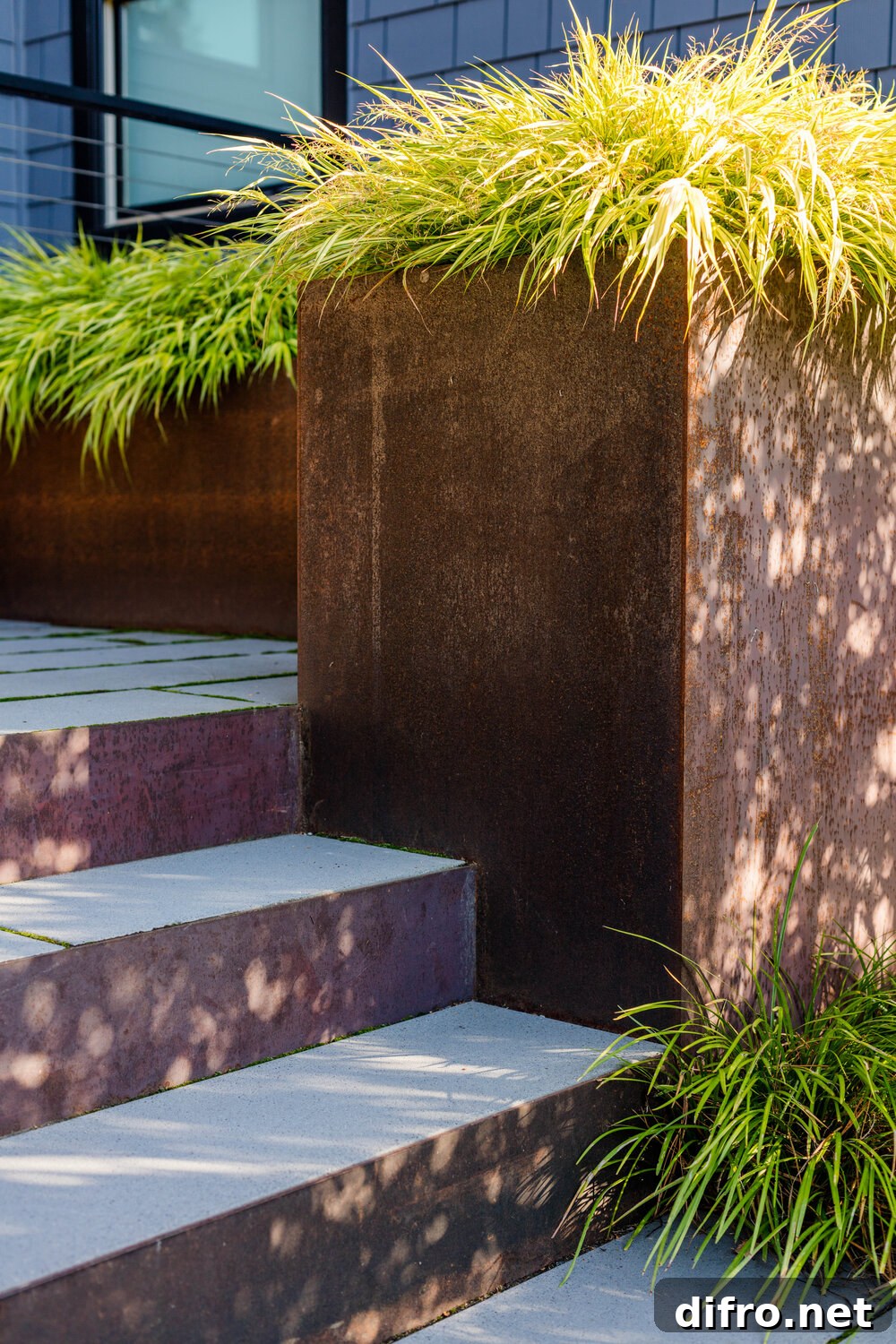Steel and concrete steps welcome you into the lovely home and series of patios around it