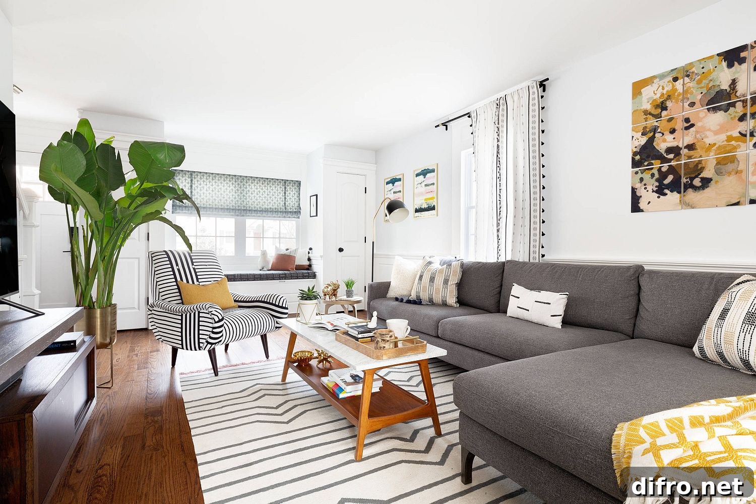 Accent chair with multiple stripe widths paired with a striped rug