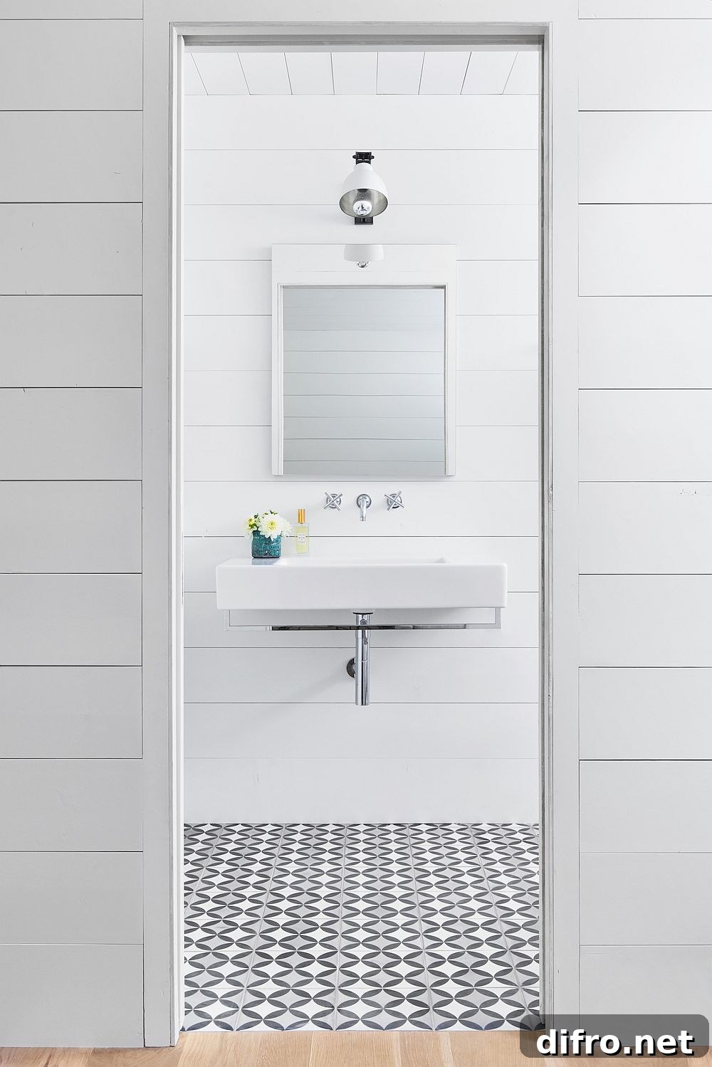 White bathroom with patterned tile floor and a space-savvy design