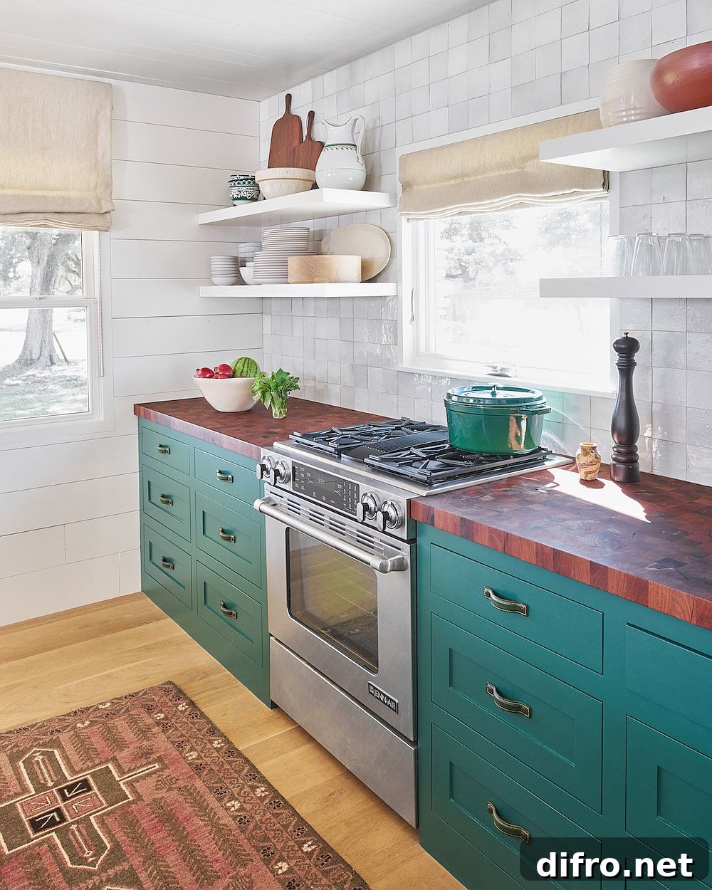 Butcher block kitchen countertops combined with teal cabinets and white tiled backsplash