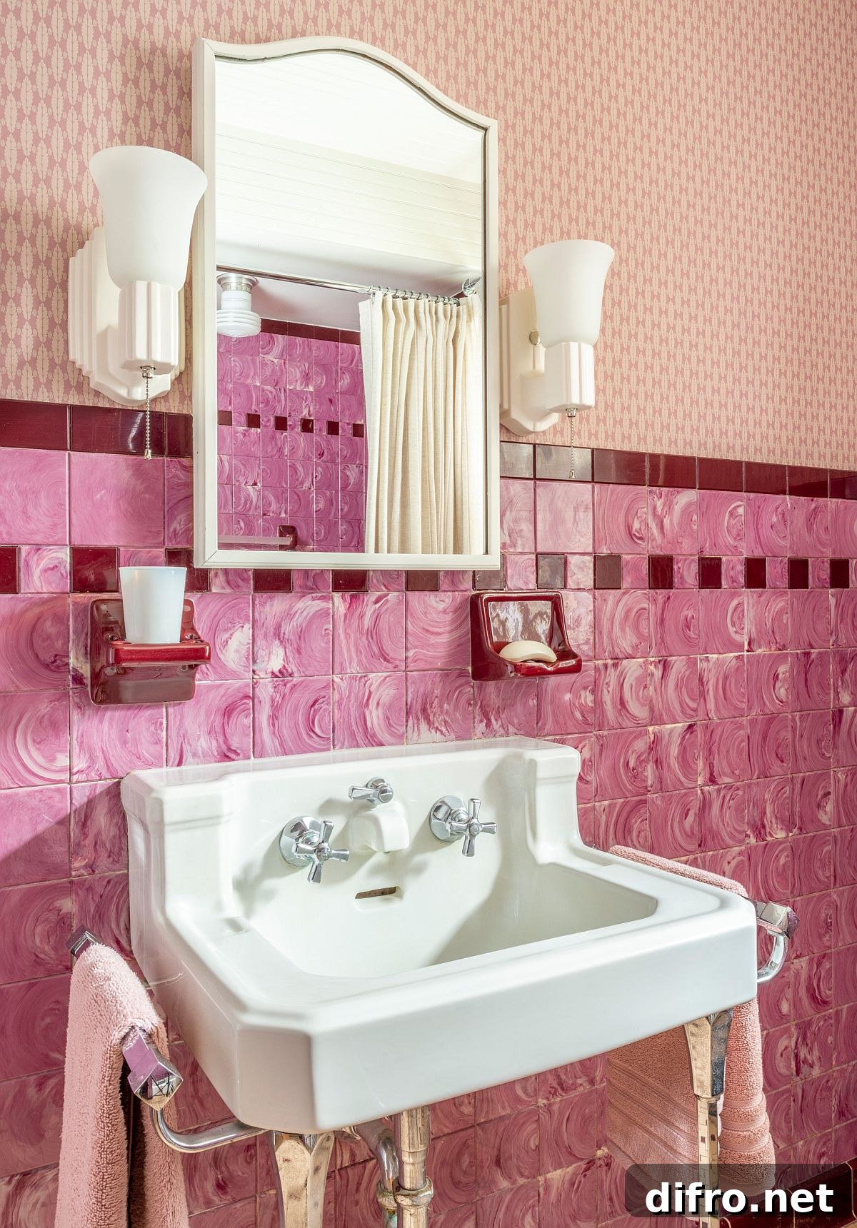 Pink tiles on the wall with a wall-mounted sink