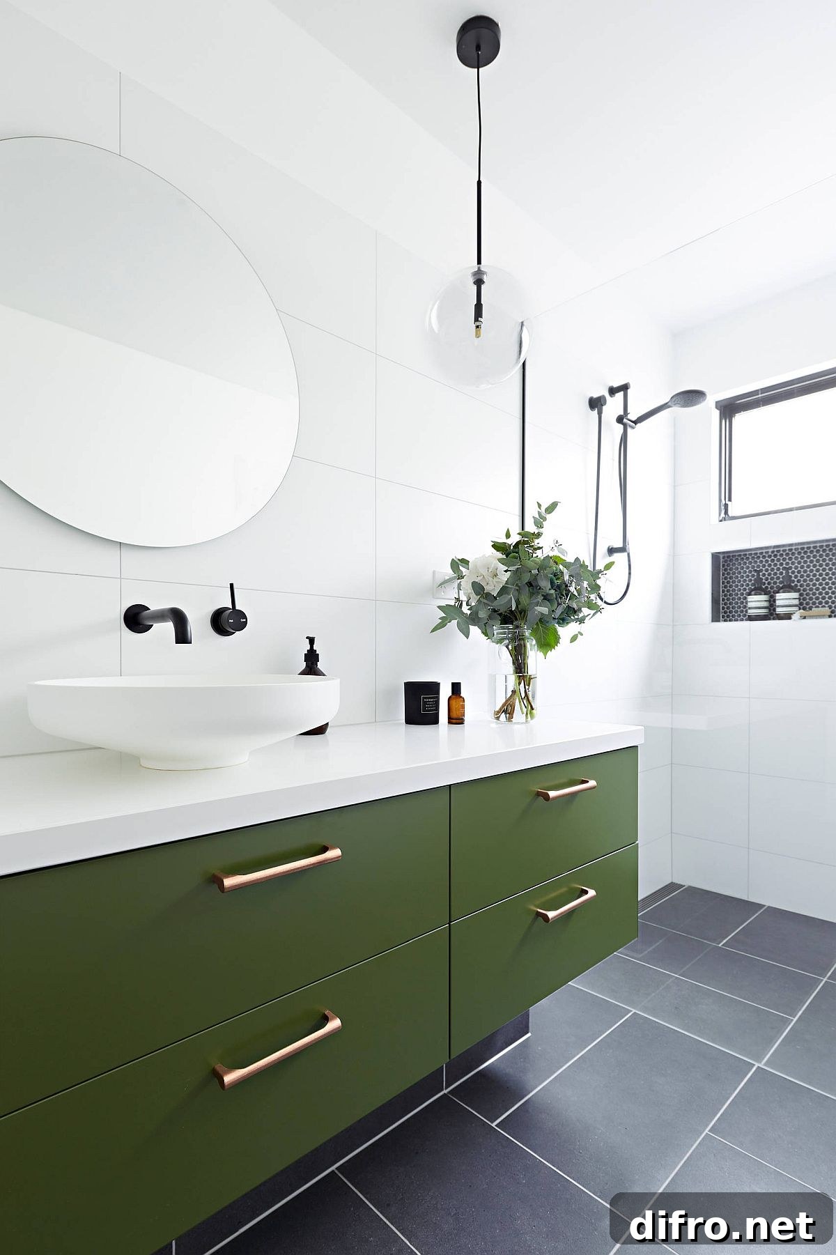 Dark olive green vanity in a white bathroom