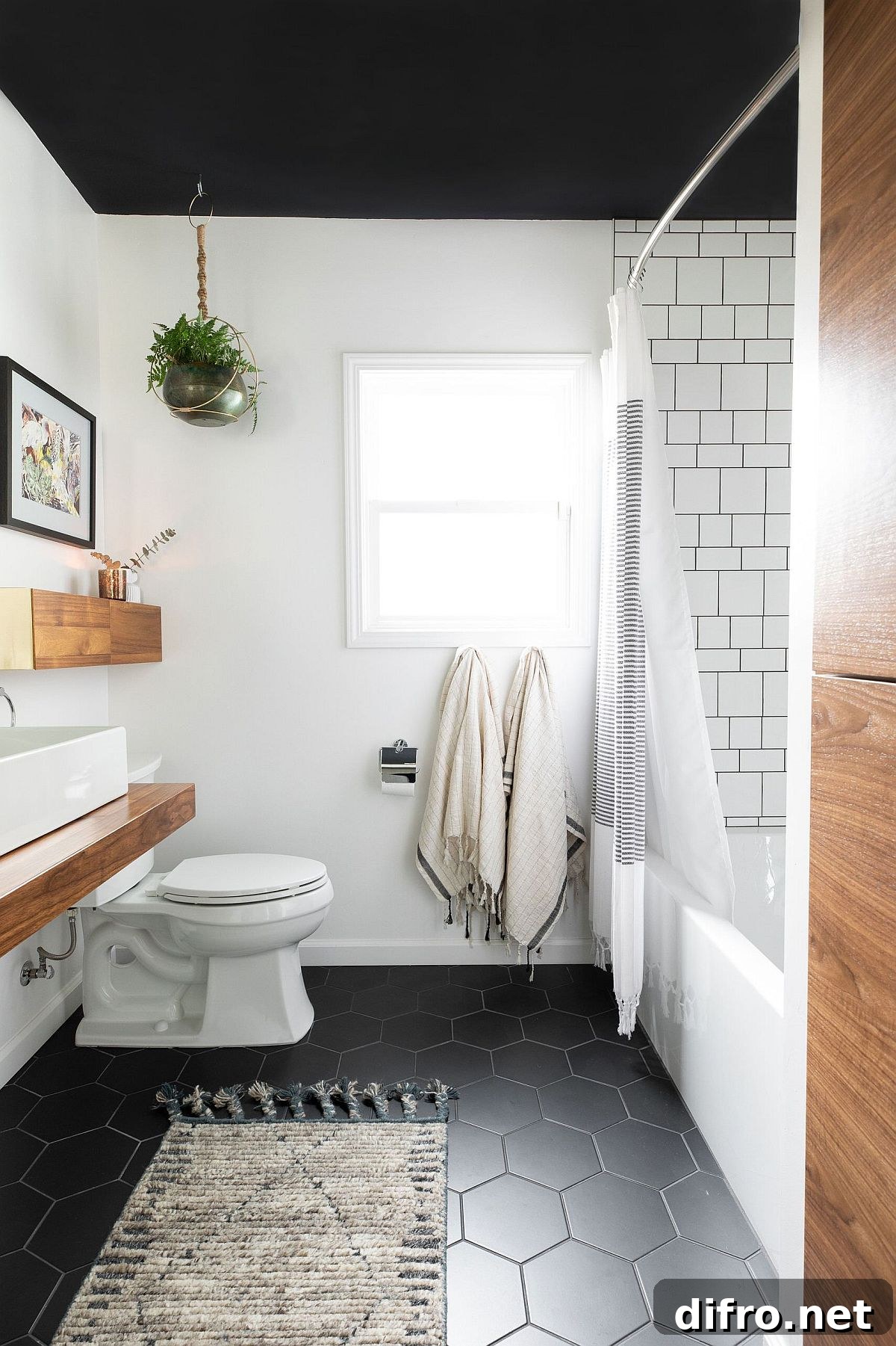 Modern black-and-white bathroom with hexagonal tiles and wooden vanity
