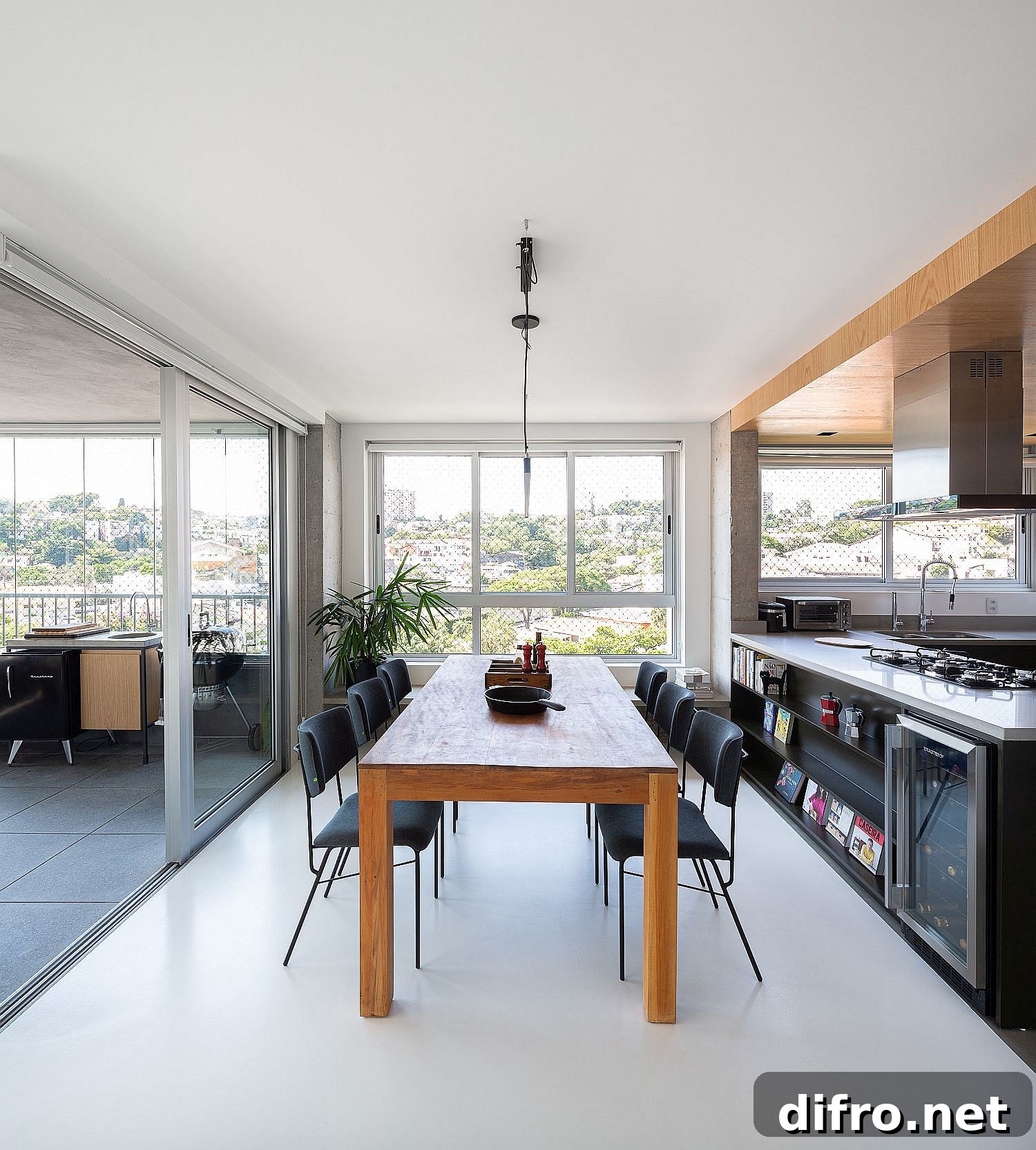 Dining table positioned between the kitchen and enclosed balcony