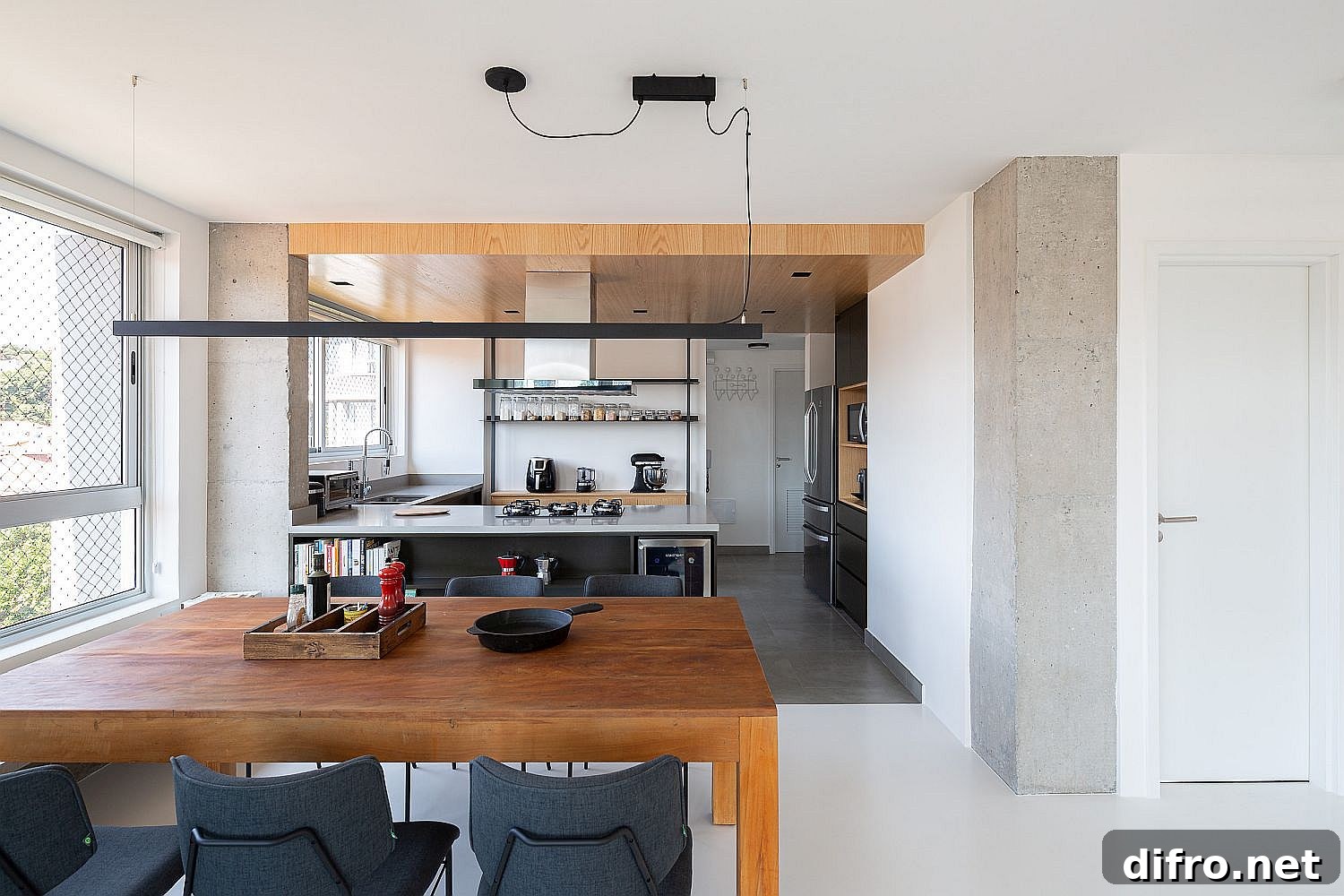Wooden ceiling and floor change that help define the kitchen area in the open plan