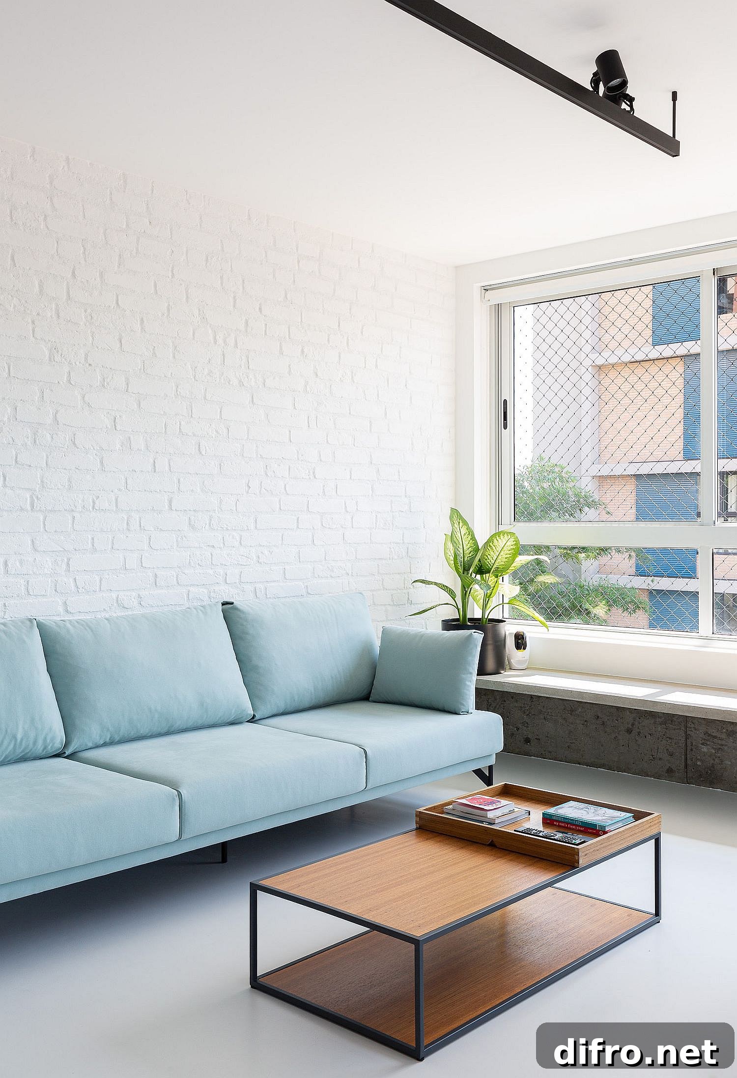 Blue sofa against a white brick wall backdrop in the living room