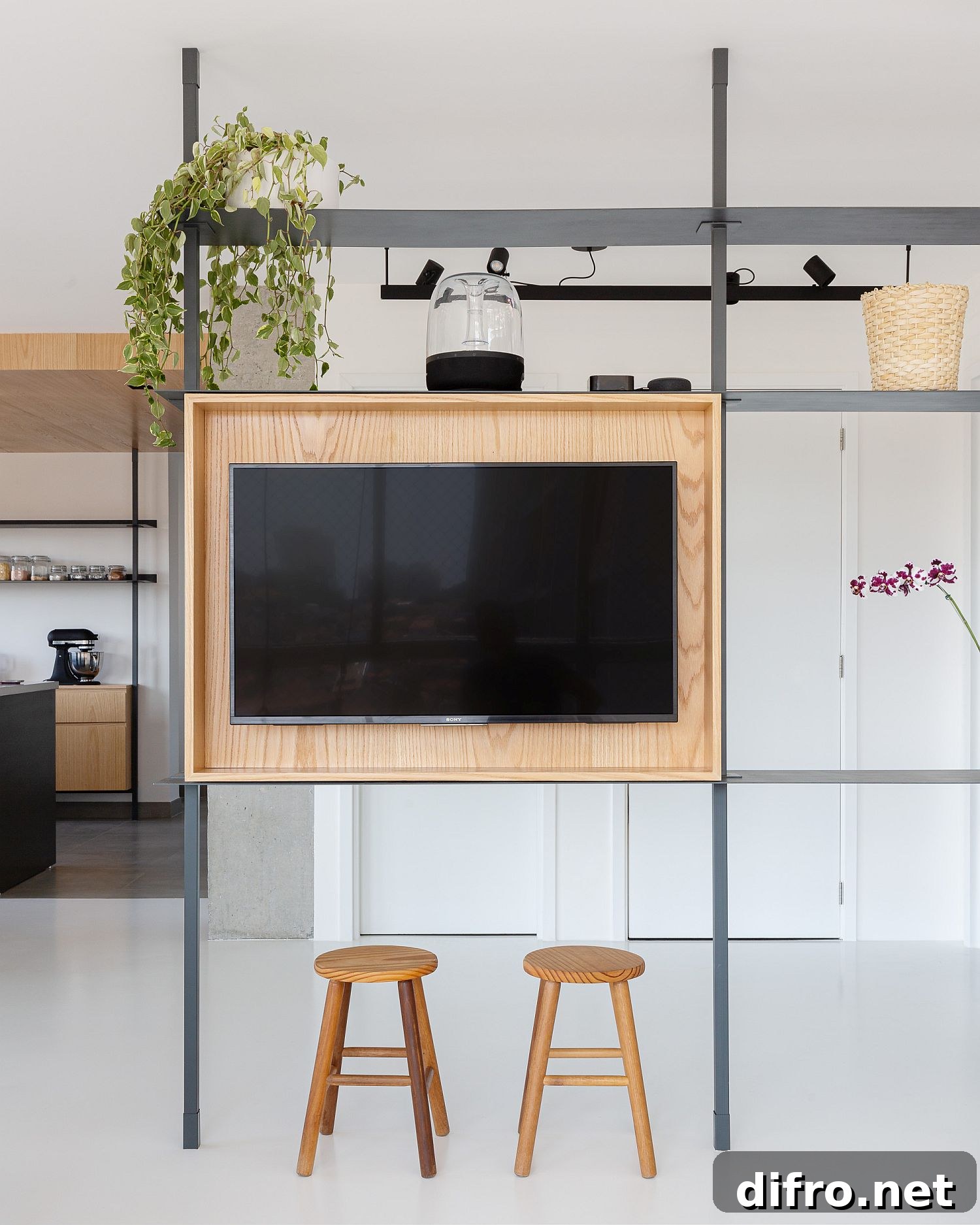 Minimal room divider with an elegant frame and integrated TV stand