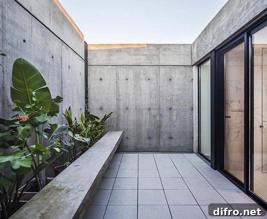 Private concrete courtyard of the house with custom bench