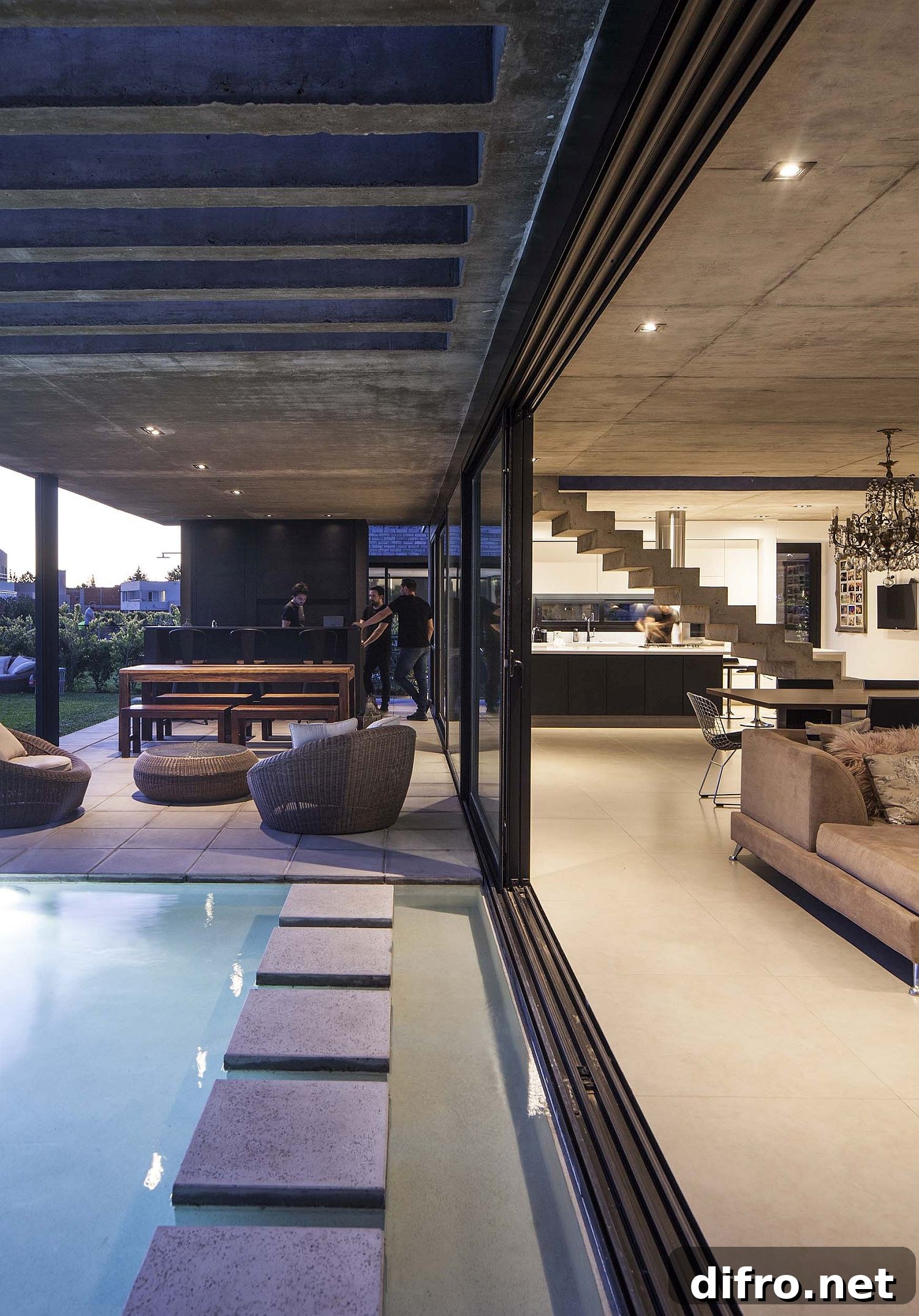 Sliding glass doors connect the spacious living area with the pool and the al fresco dining