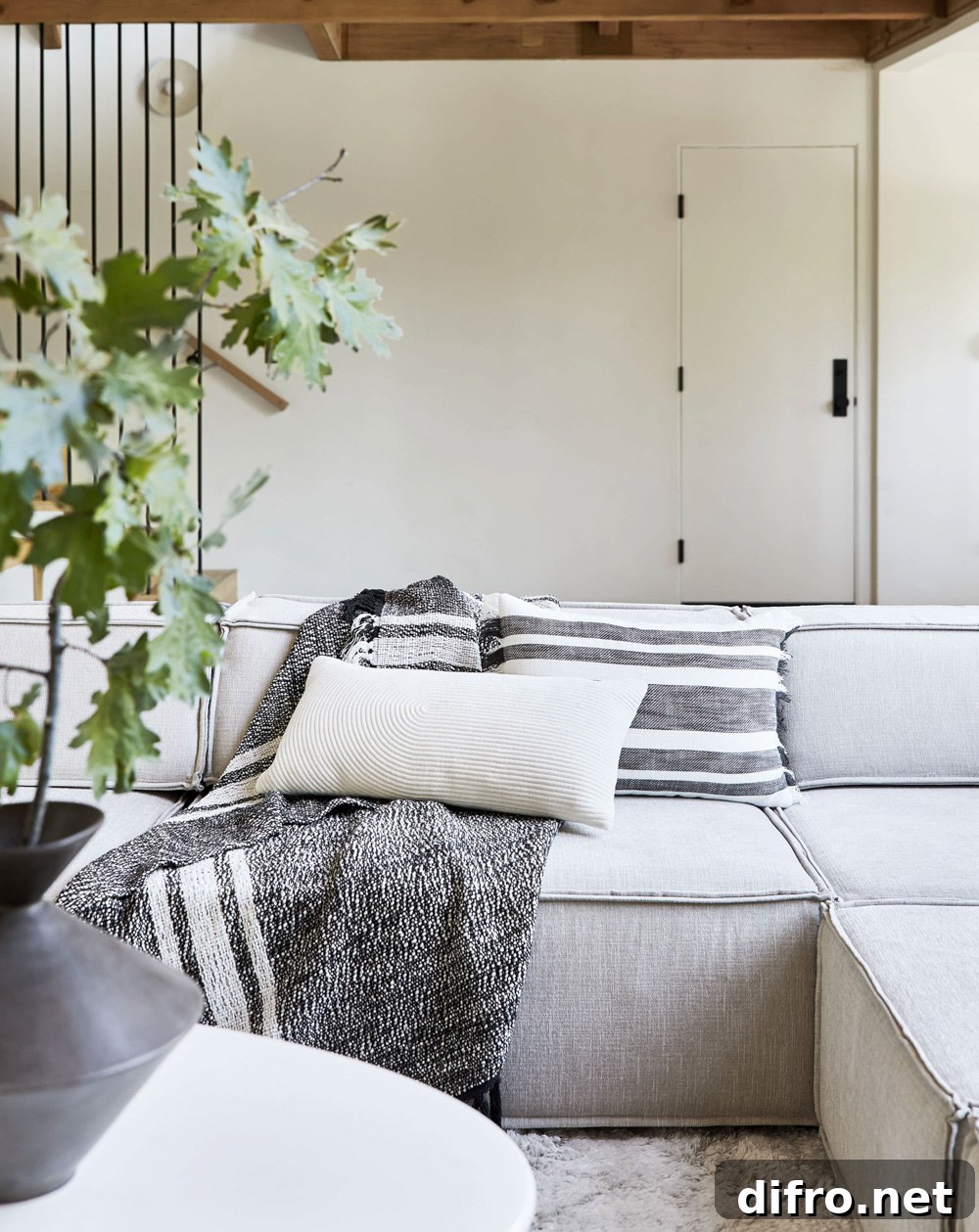 Cozy throw and textured pillows in a neutral living room