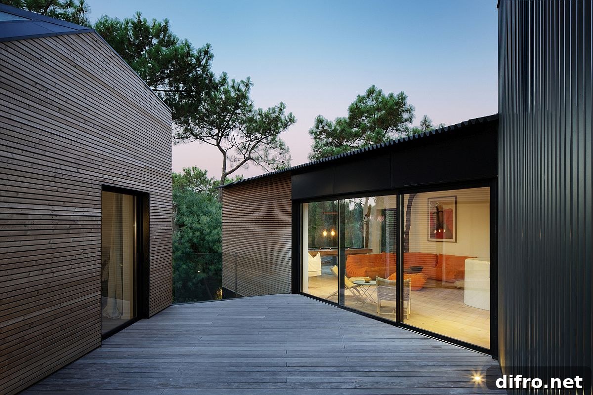 Spacious wooden deck connects the two cabins inside the Holiday Home in France