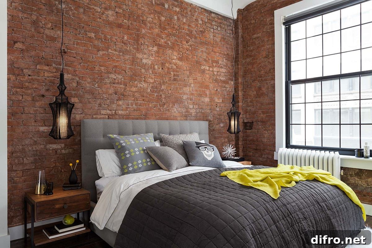 Exposed brick walls in modern industrial bedroom
