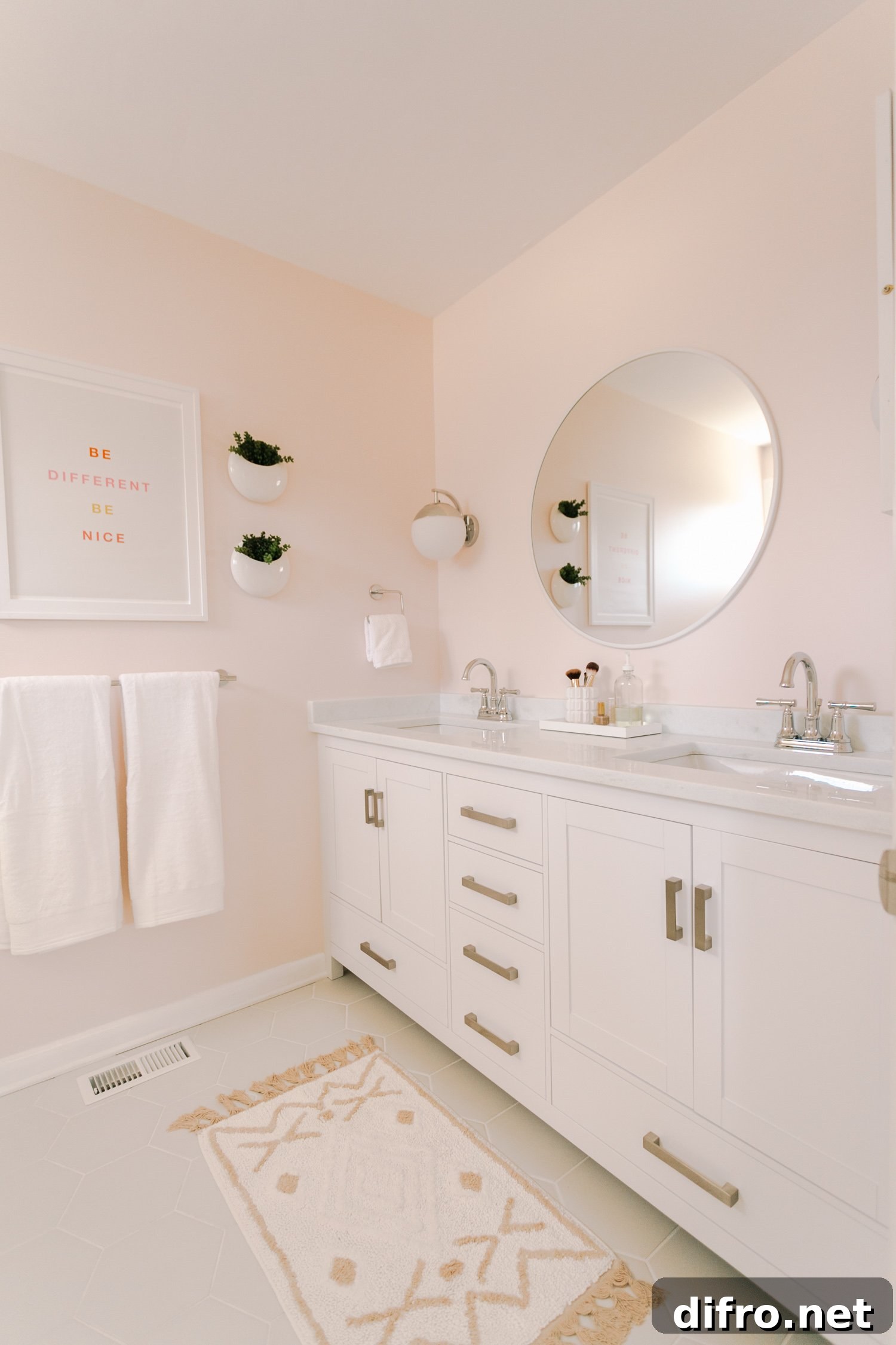 Round white mirror in blush bathroom
