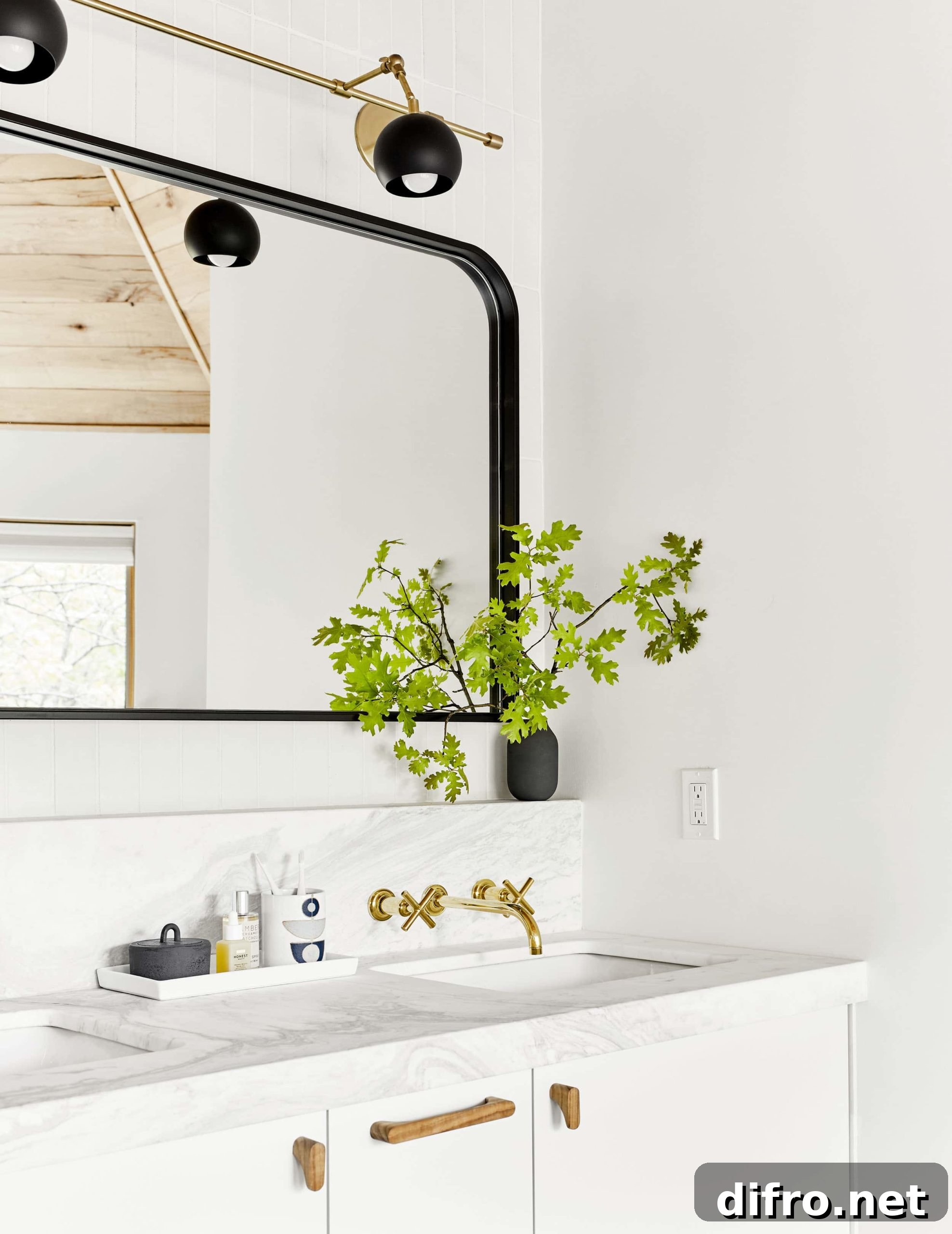 Black mirror with curved edges in bright bathroom