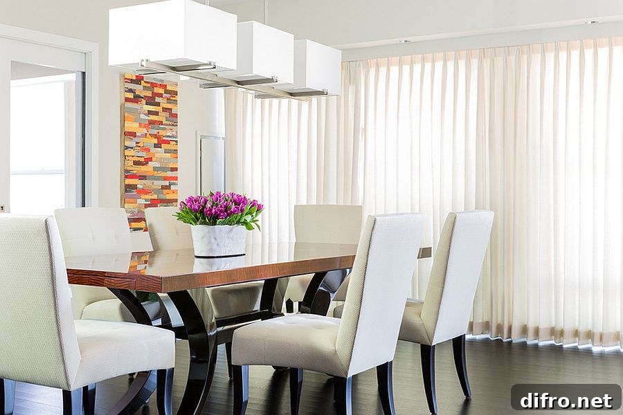 Modern dining room in white with sheer curtains