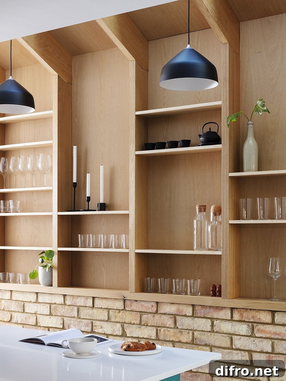 Black pendant lights contrast with wood and brick interior