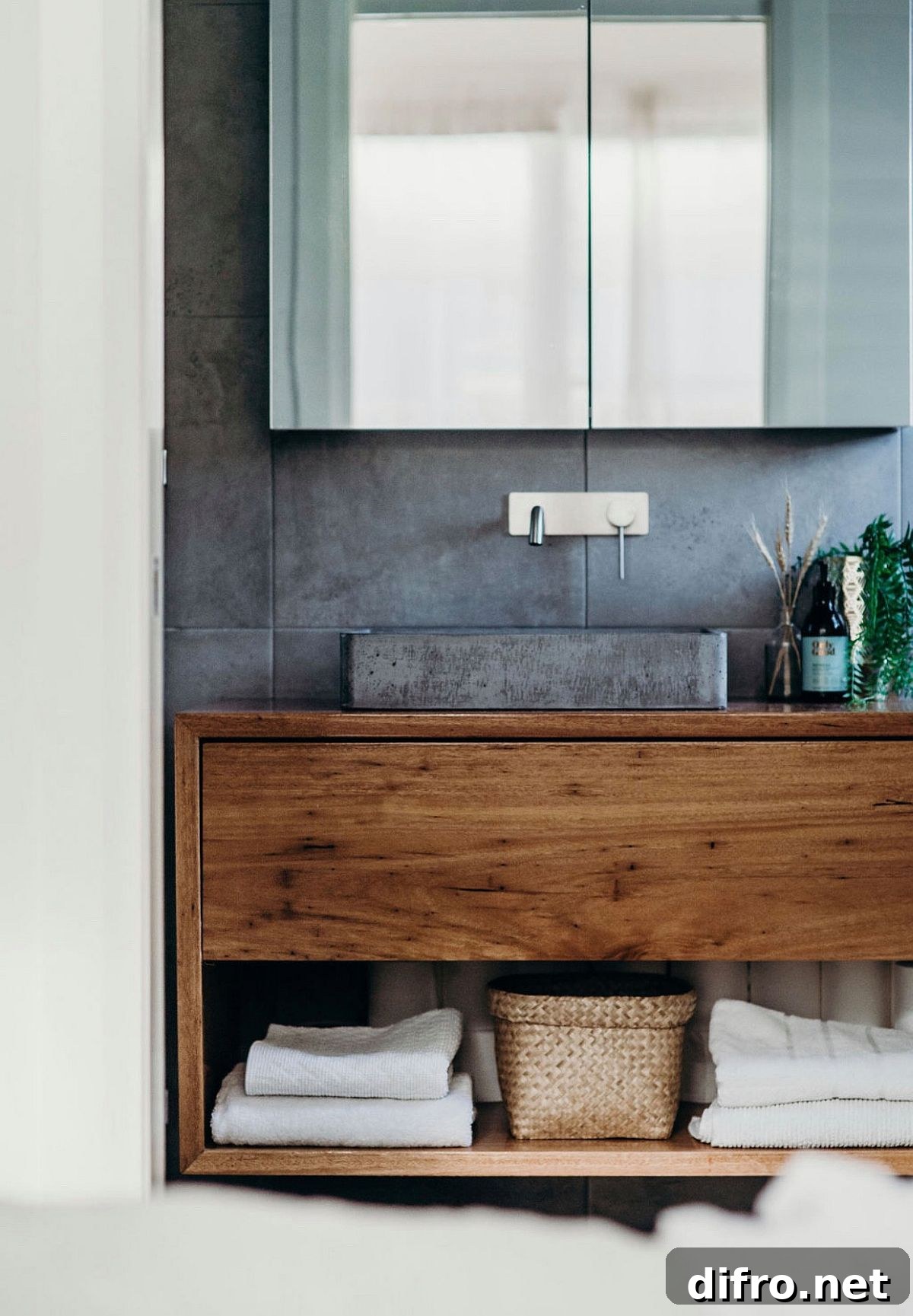 Concrete accent wall for the bathroom in white with a wooden vanity