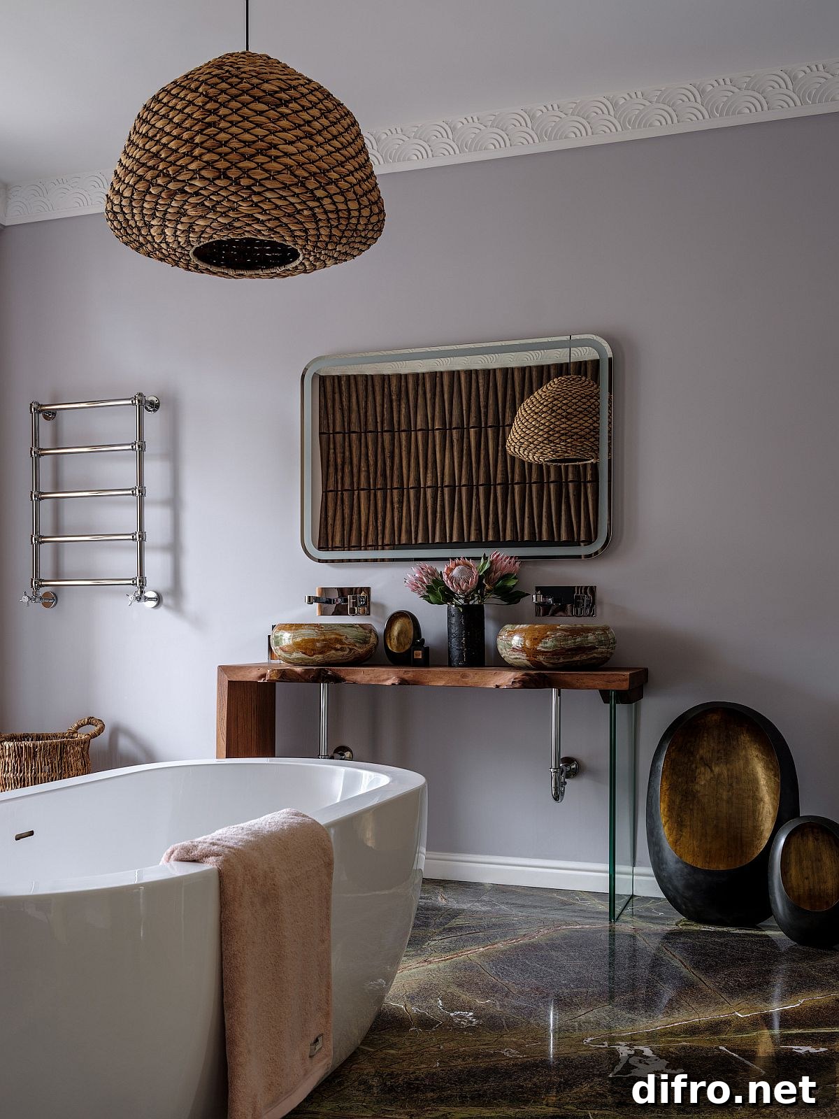 Modern eclectic bathroom in gray with stone floor and freestanding bathtub in white
