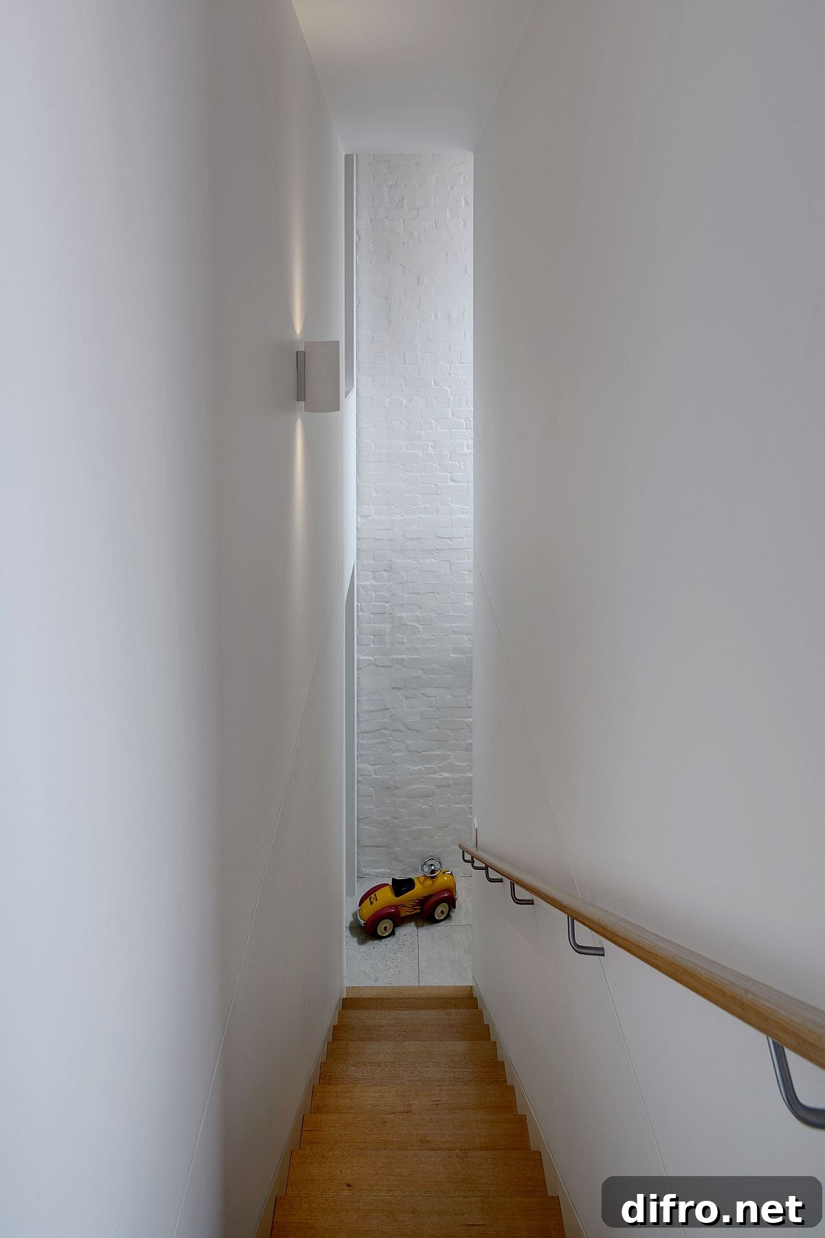 Narrow staircase leading to the top level of the house