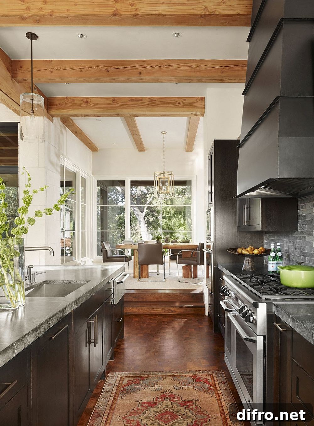 Open kitchen and dining area with exposed wood beams