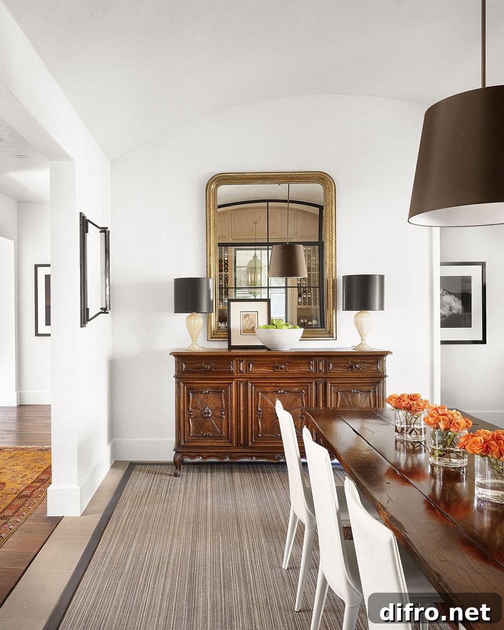Dining room with gold mirror frame and dark lamps for an elegant touch