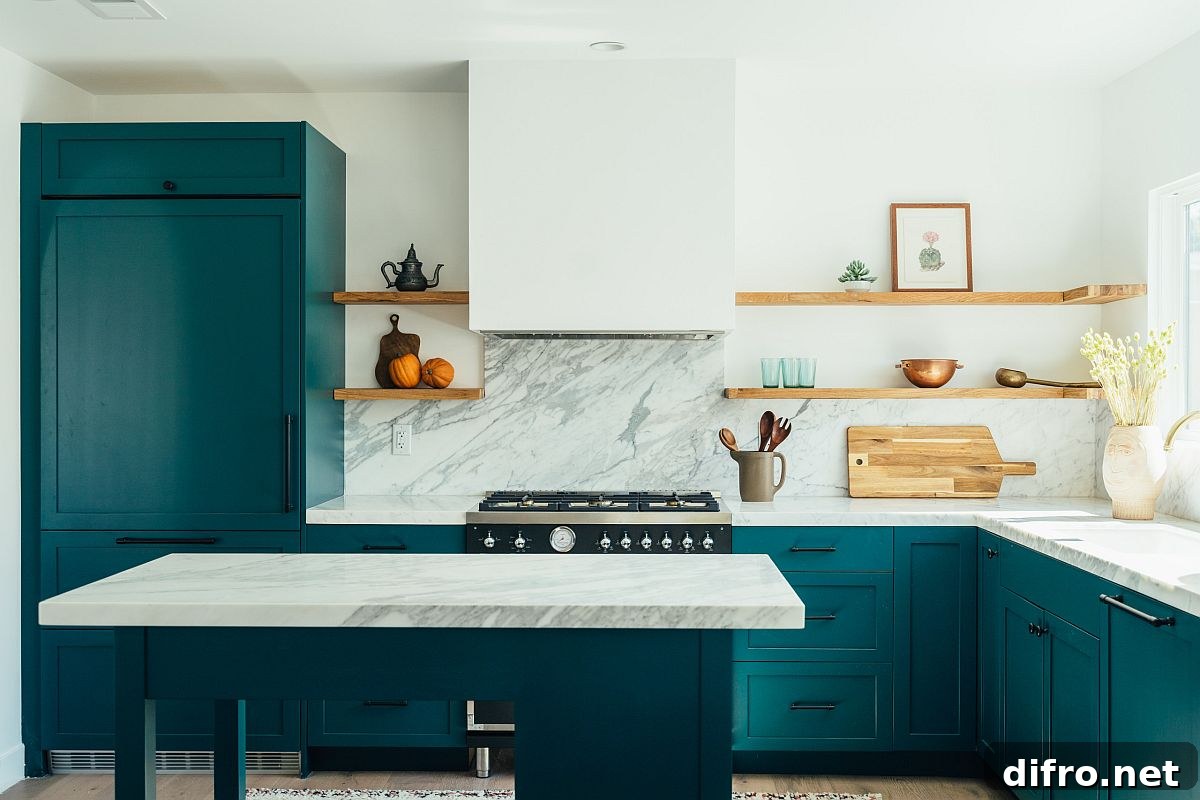 Bright teal cabinets with white marble finishes