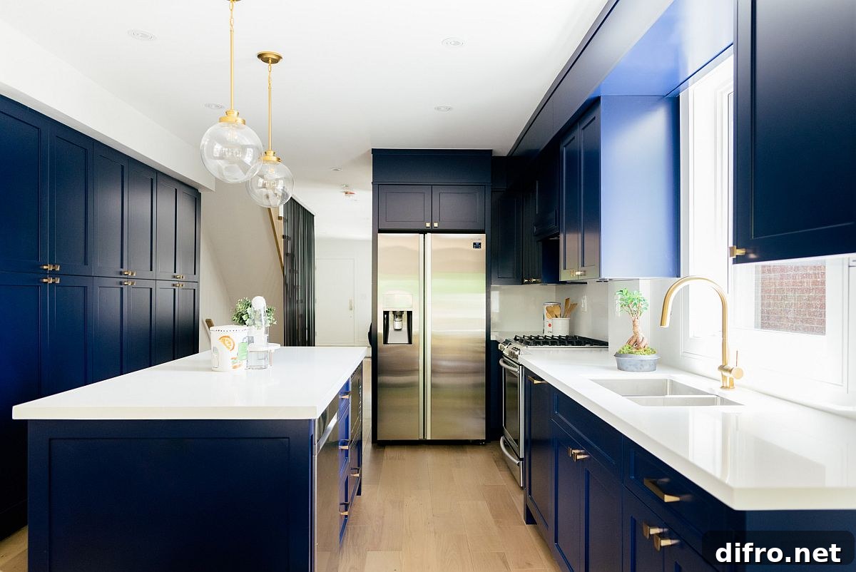 White and navy blue kitchen with brass fixtures