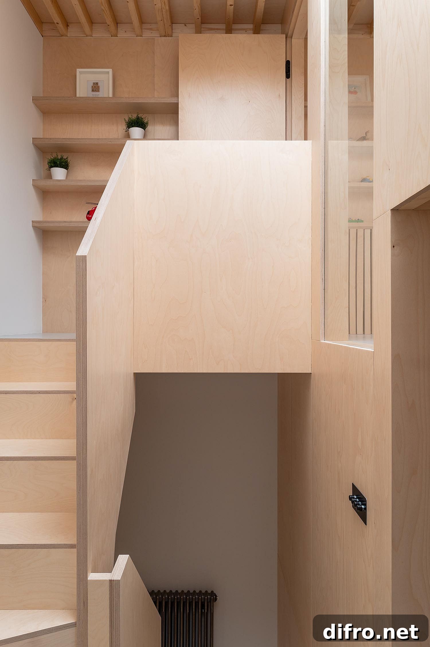 Plywood clad walls and staircase transform the interior